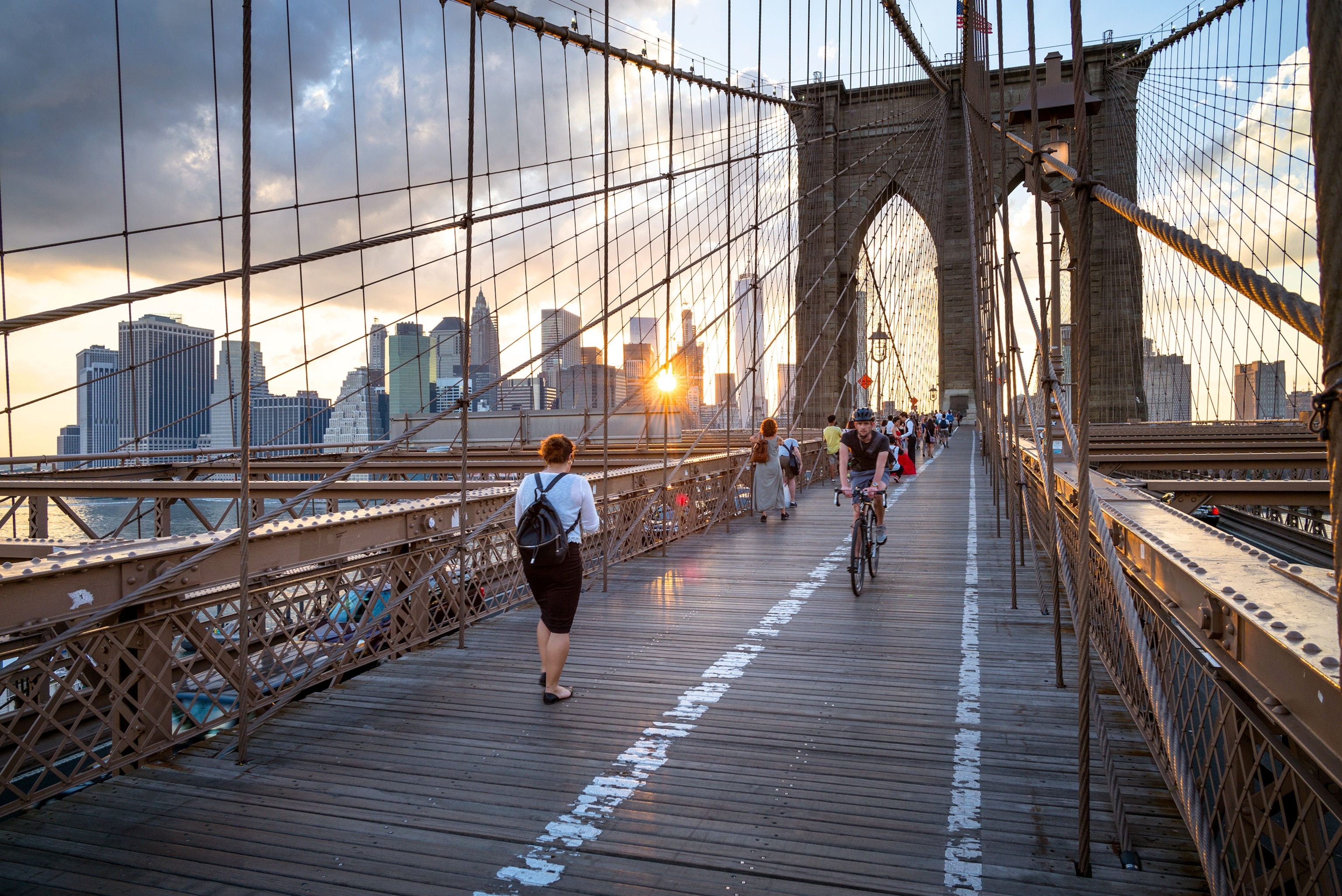 people crossing the Brooklyn Bridge in New York City, New York