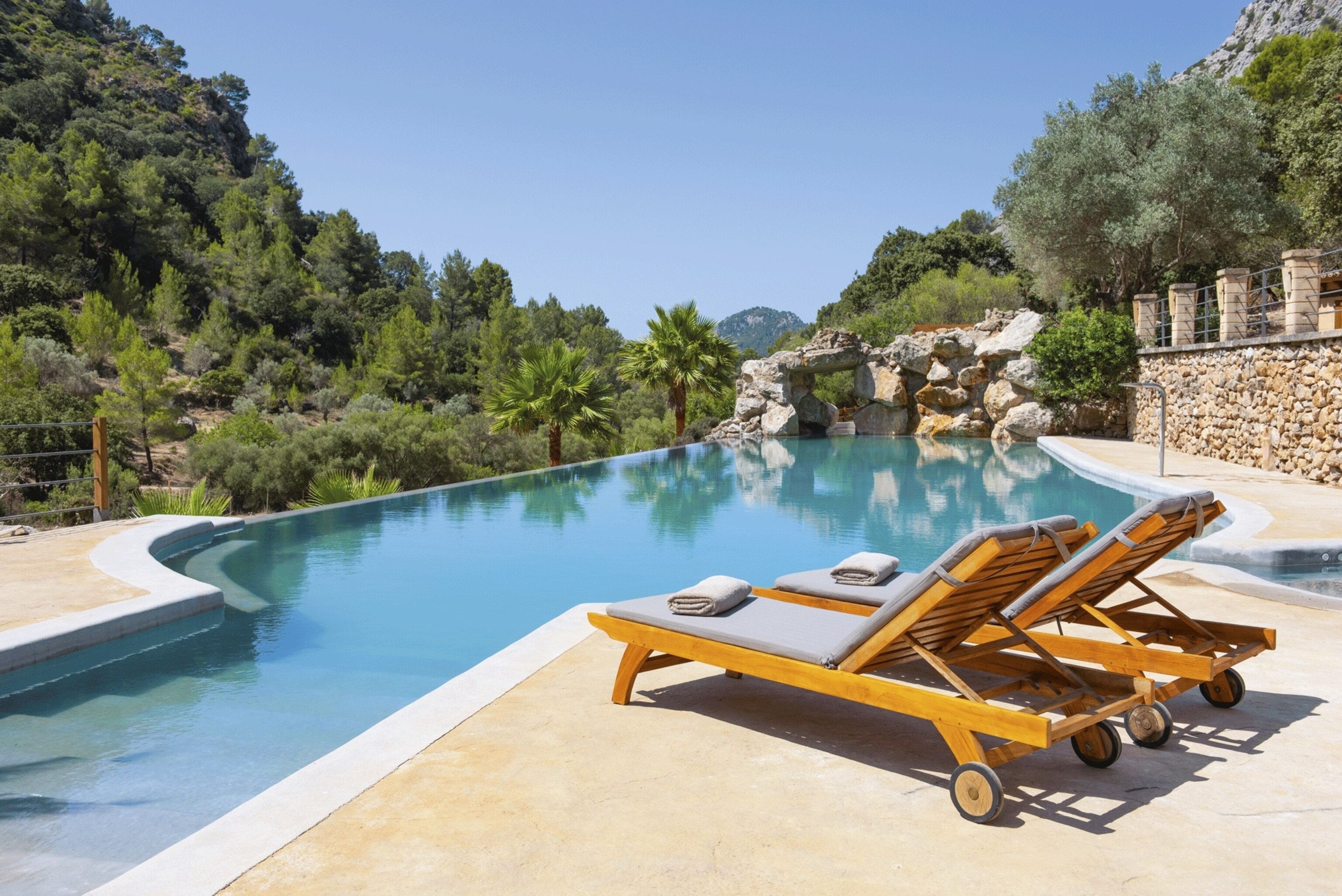 Two sun lougers by the pool at LJs Ratxó Eco Luxury Retreat in Palma de Mallorca.