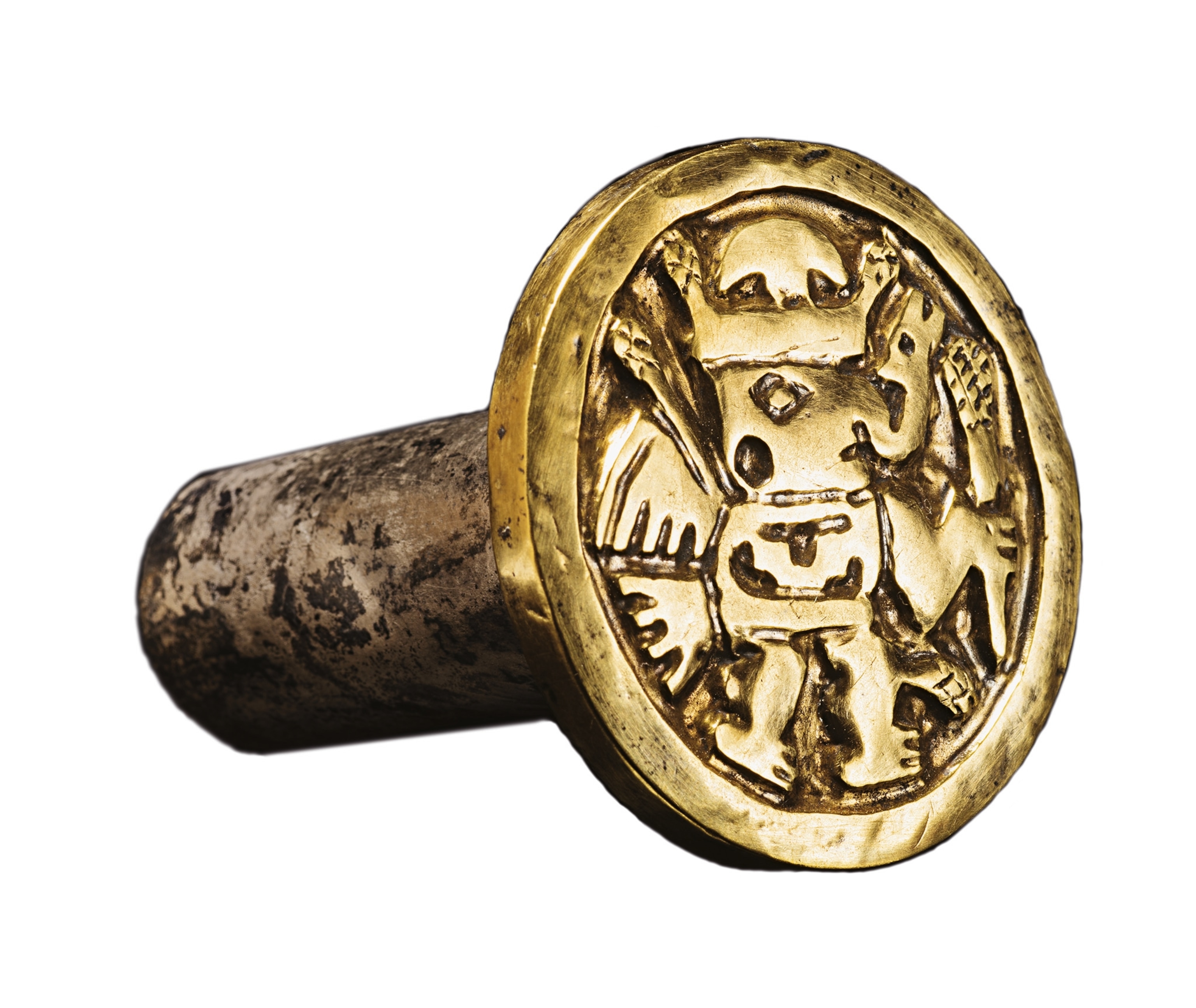 Gold ear flare with a tubular design and depiction of a winged creature.