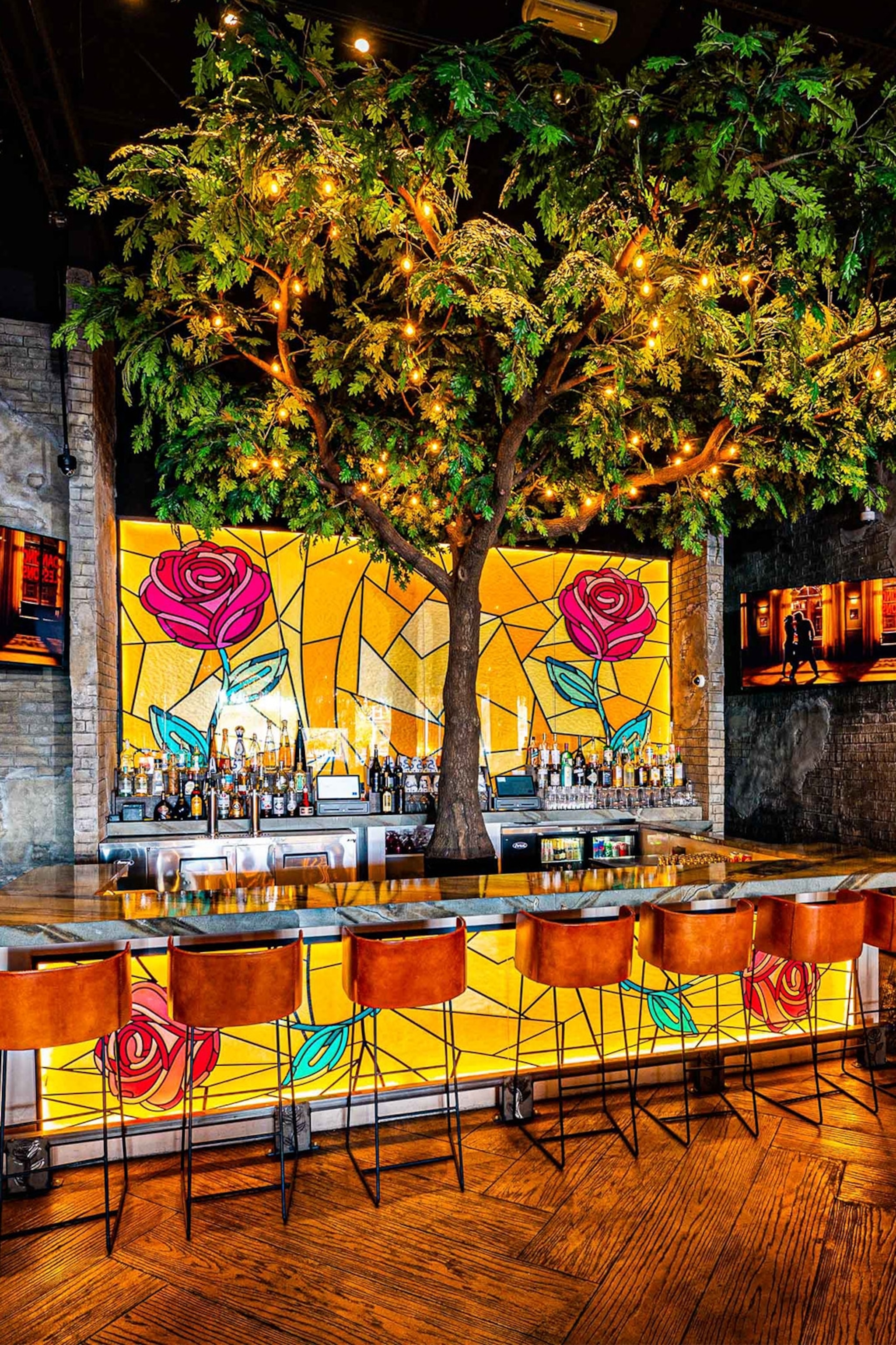 Brightly lit bar with tree at its centre