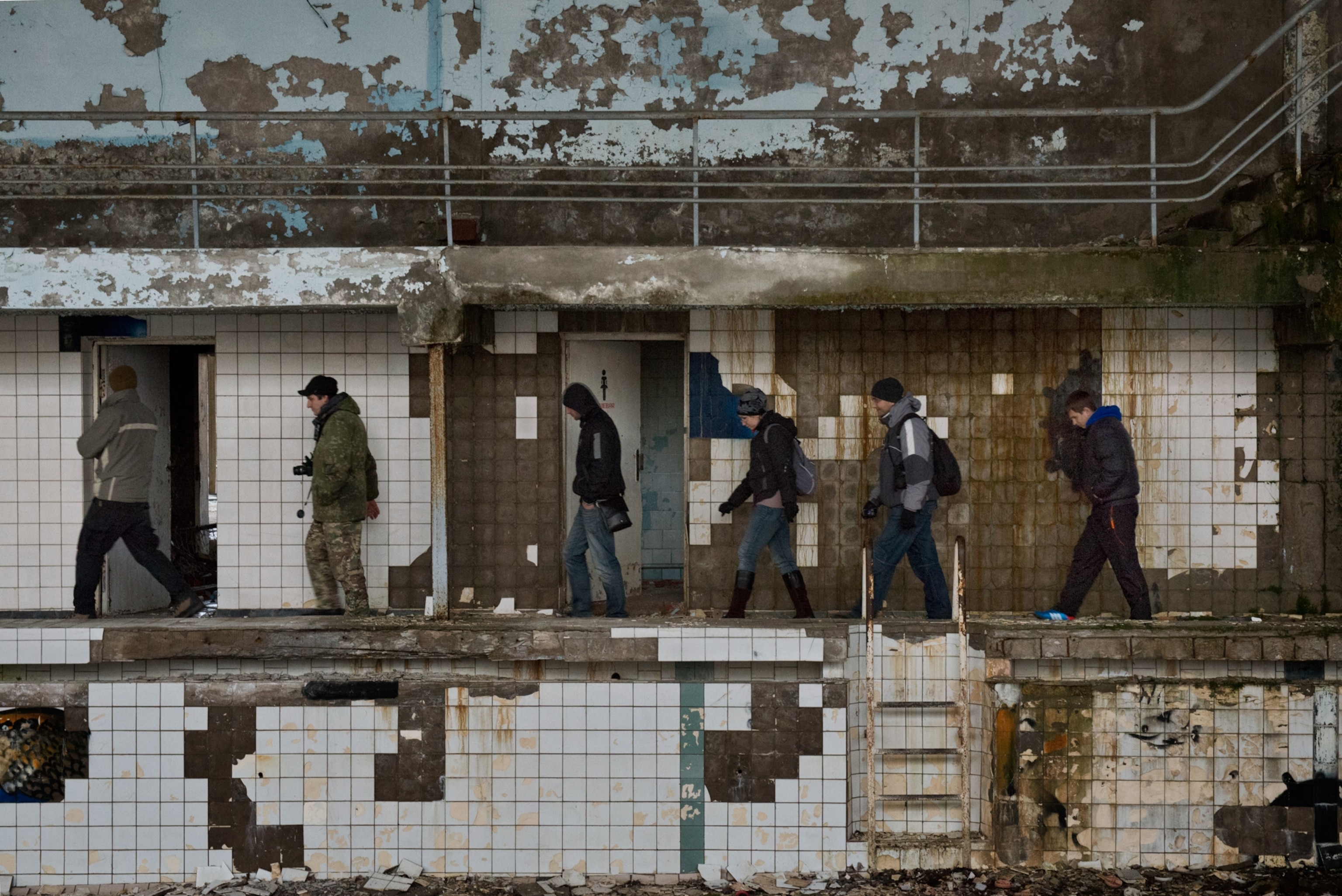 Tourists inside the swimming pool in the ghost town of Pripyat, Chernobyl exclusion zone