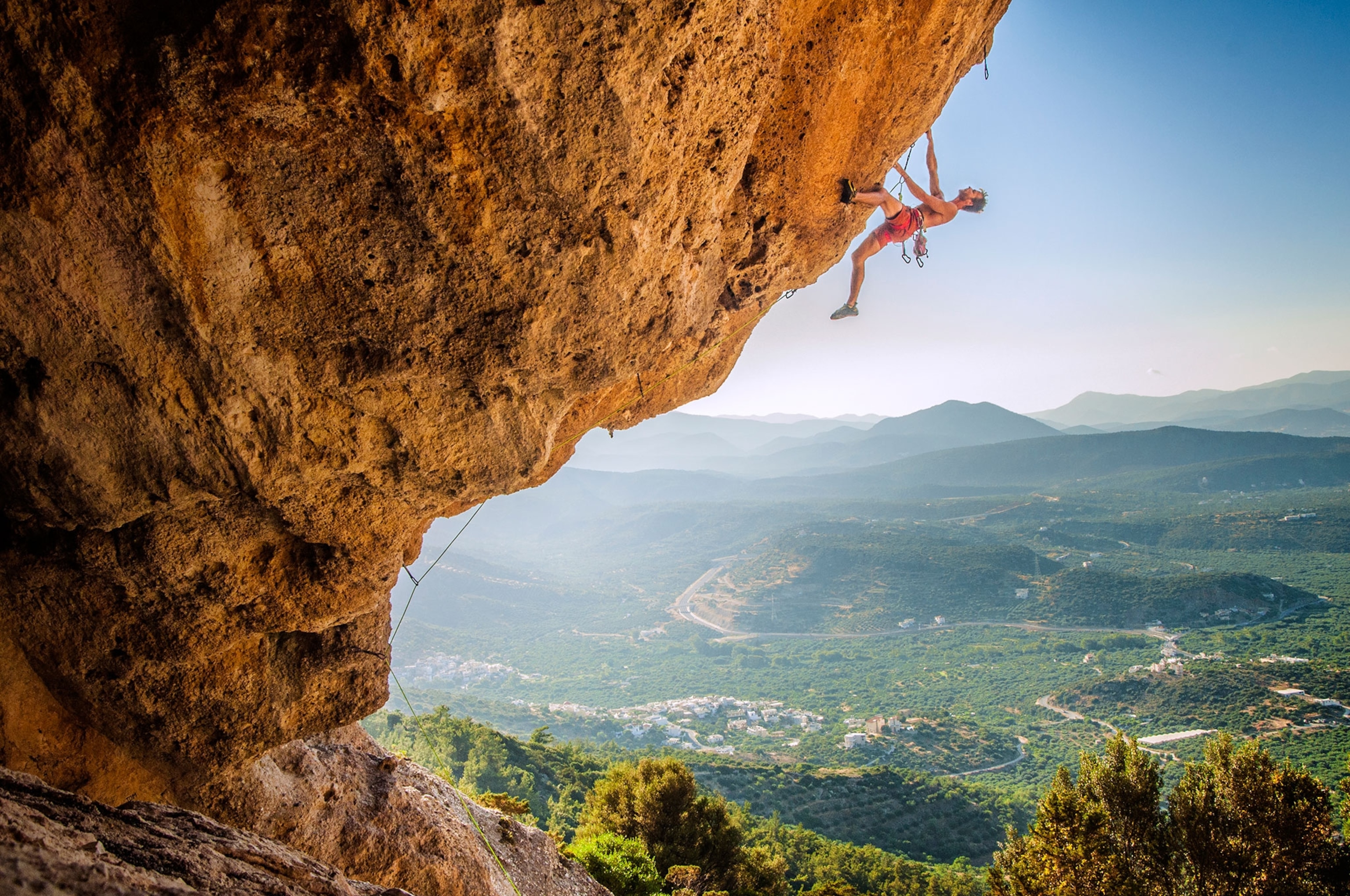 a rock climber climbing in the Pezas Fields of Easter Crete