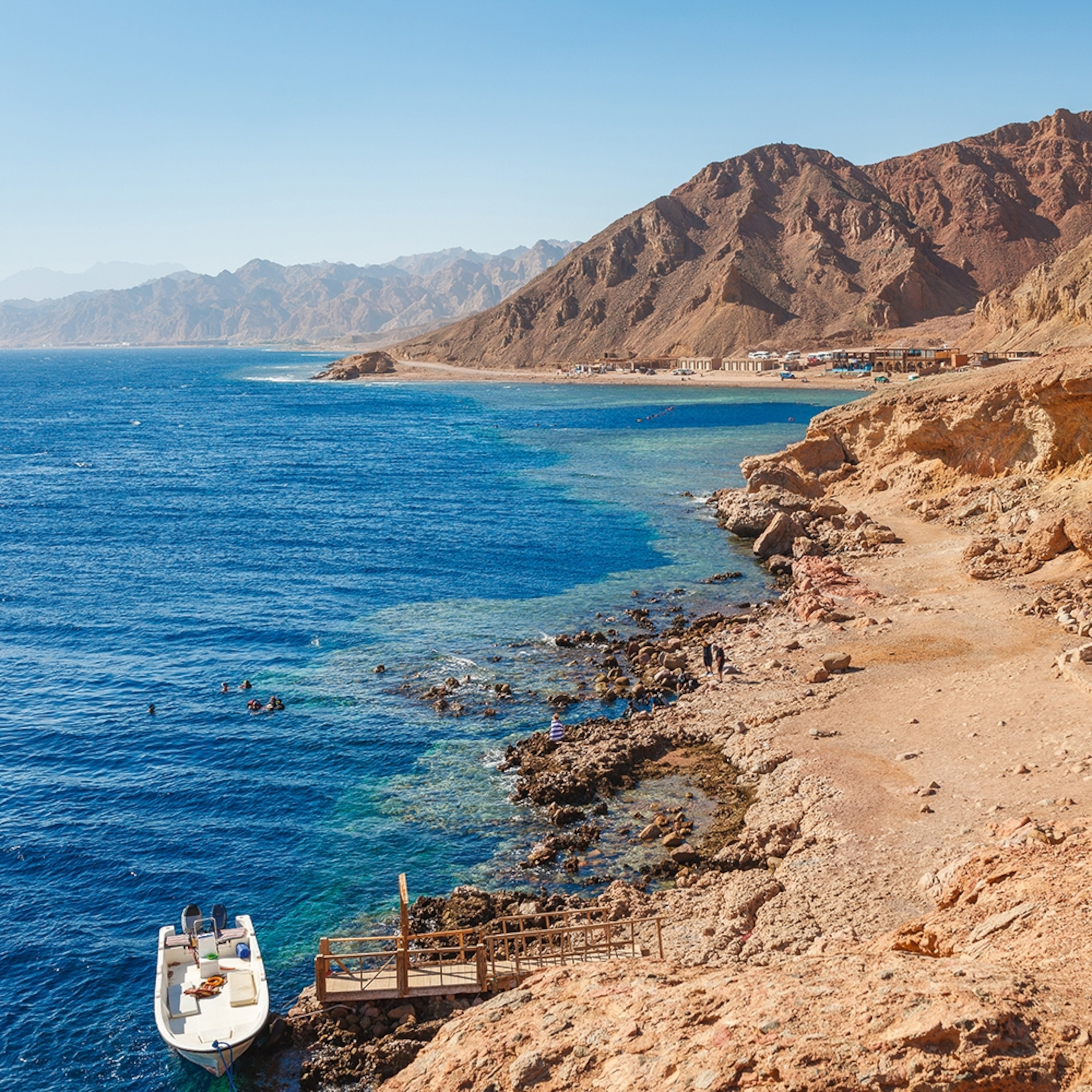A rocky and mountainous coastline in Egypt with clear, blue ocean water.