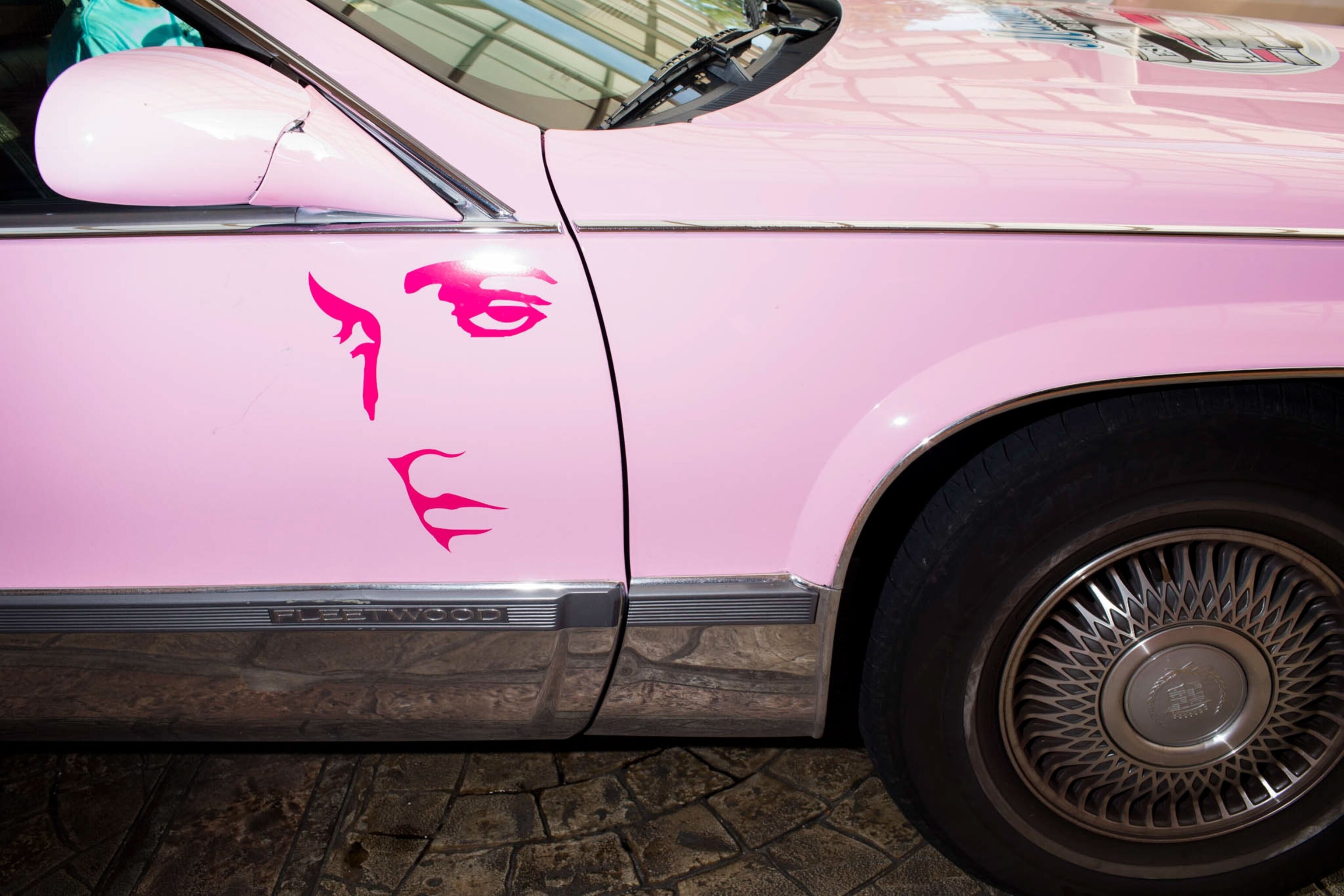 a pink car with Elvis's face on it