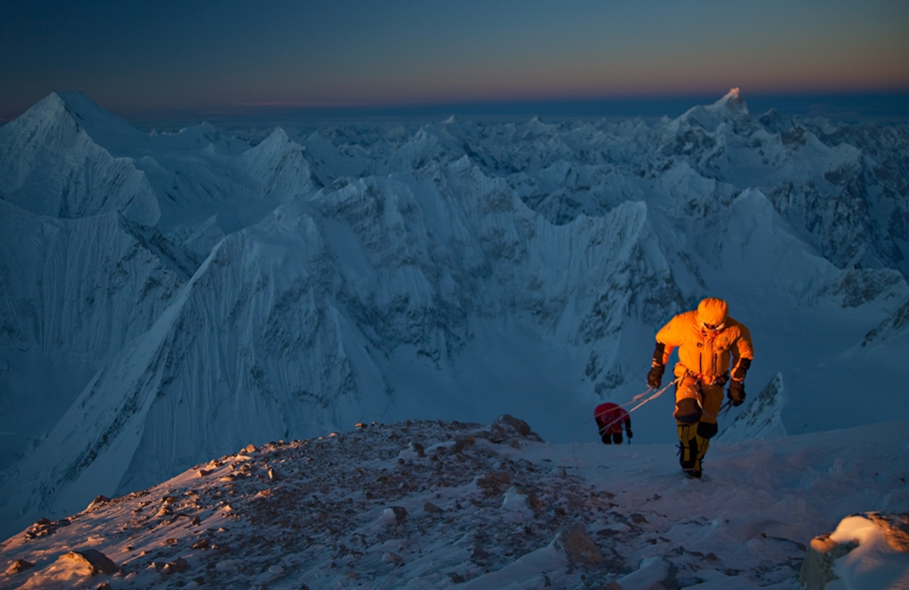 Climbers in the light of the setting sun on Gasherbrum II