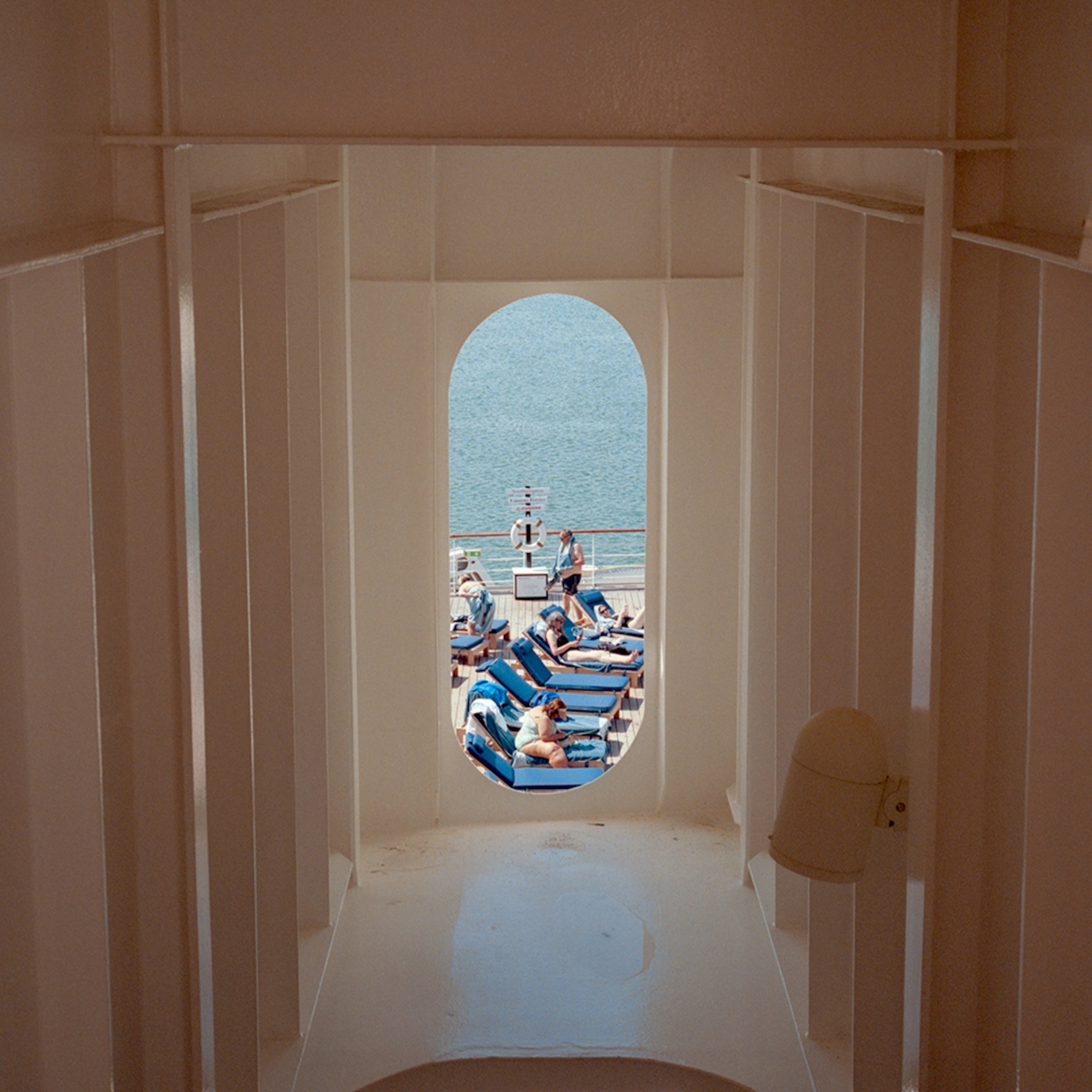 A symmetrical shot taken through a cruise ship door out onto the deck.