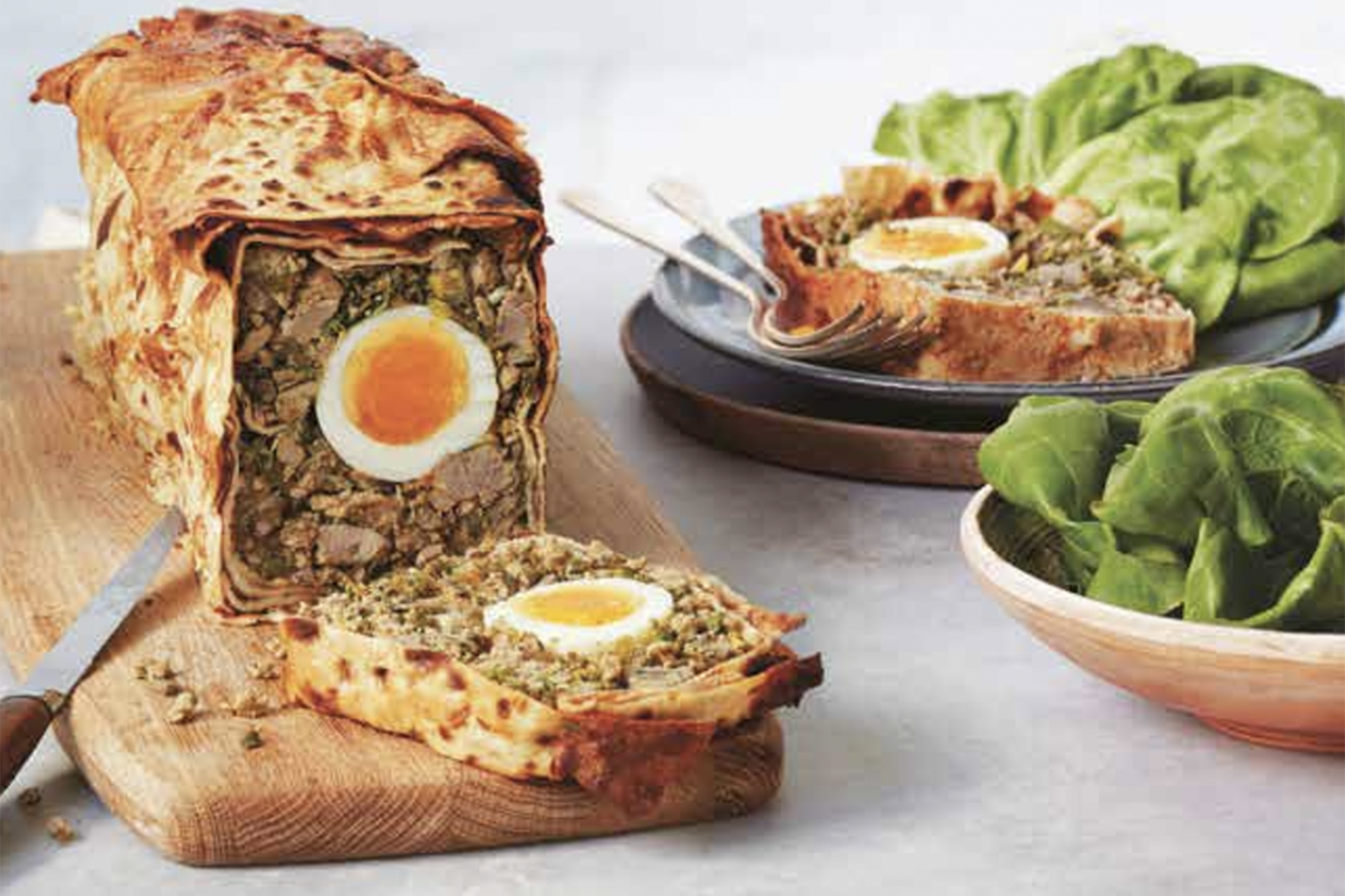 Slices of lamb meatloaf with a hard-boiled egg in the middle.