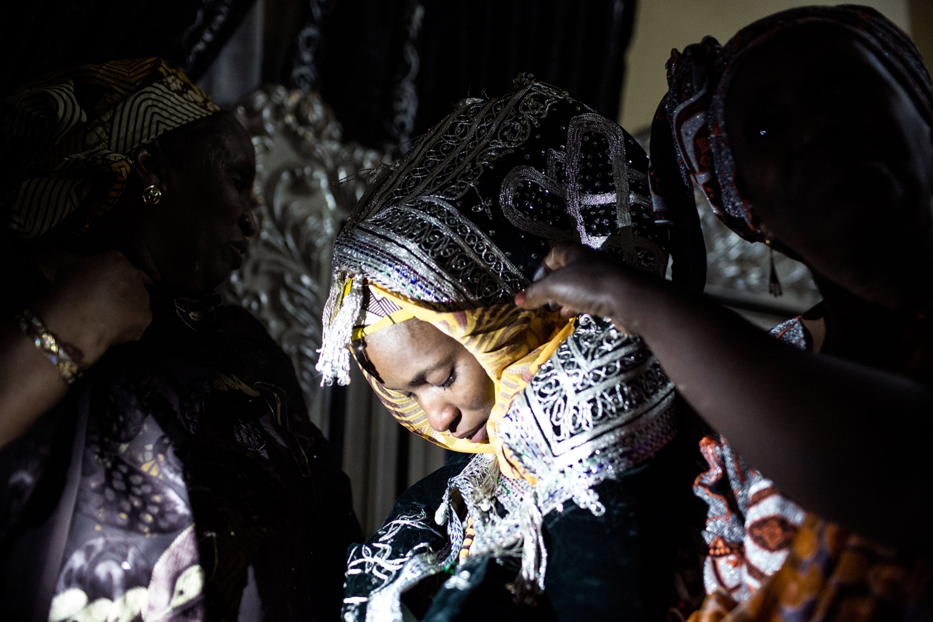 A bride is taken by her female relatives to her husband's home on the outskirts of Kano.