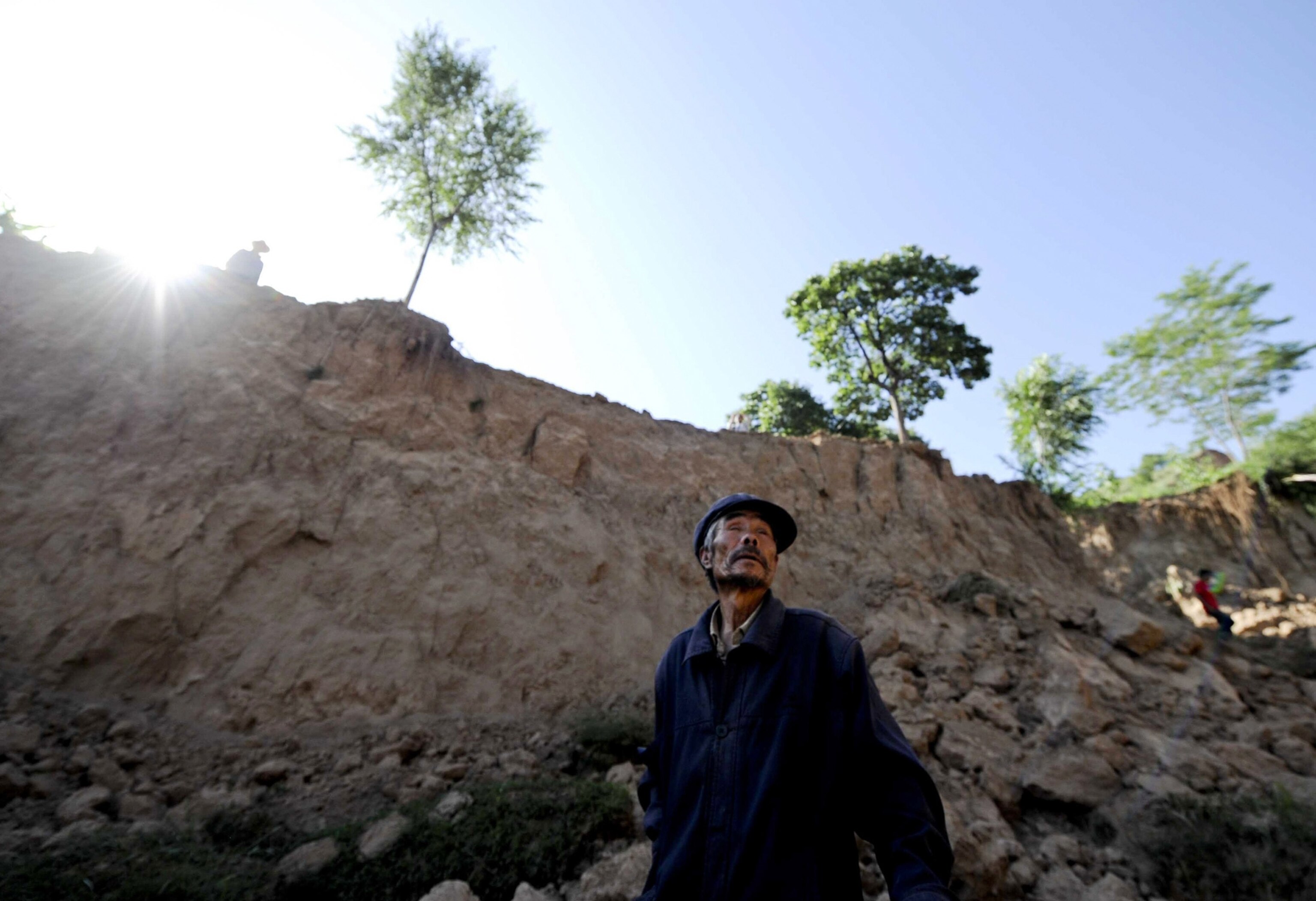 a man watching cleanup after an earthquake