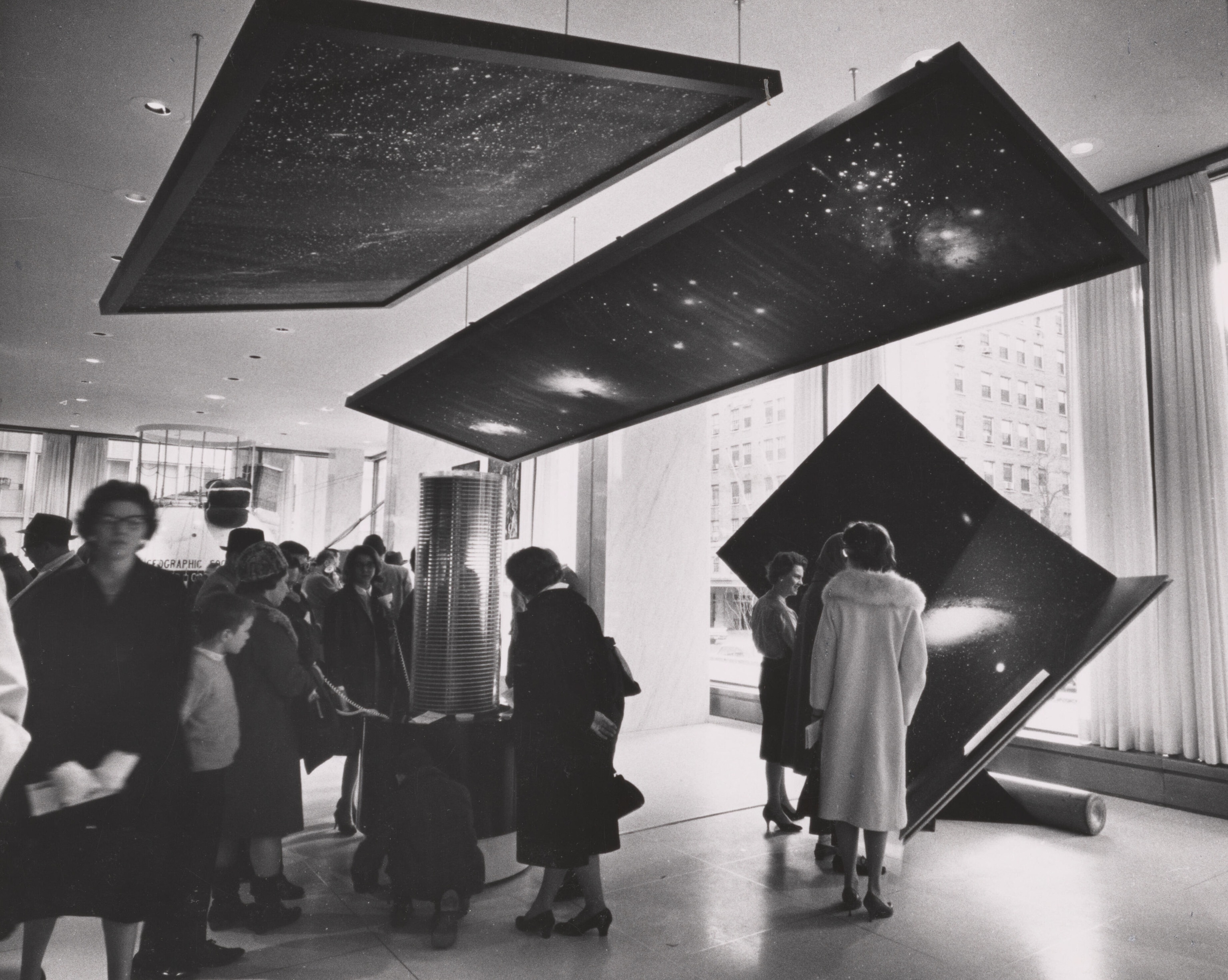 People gathered under an installation of stars