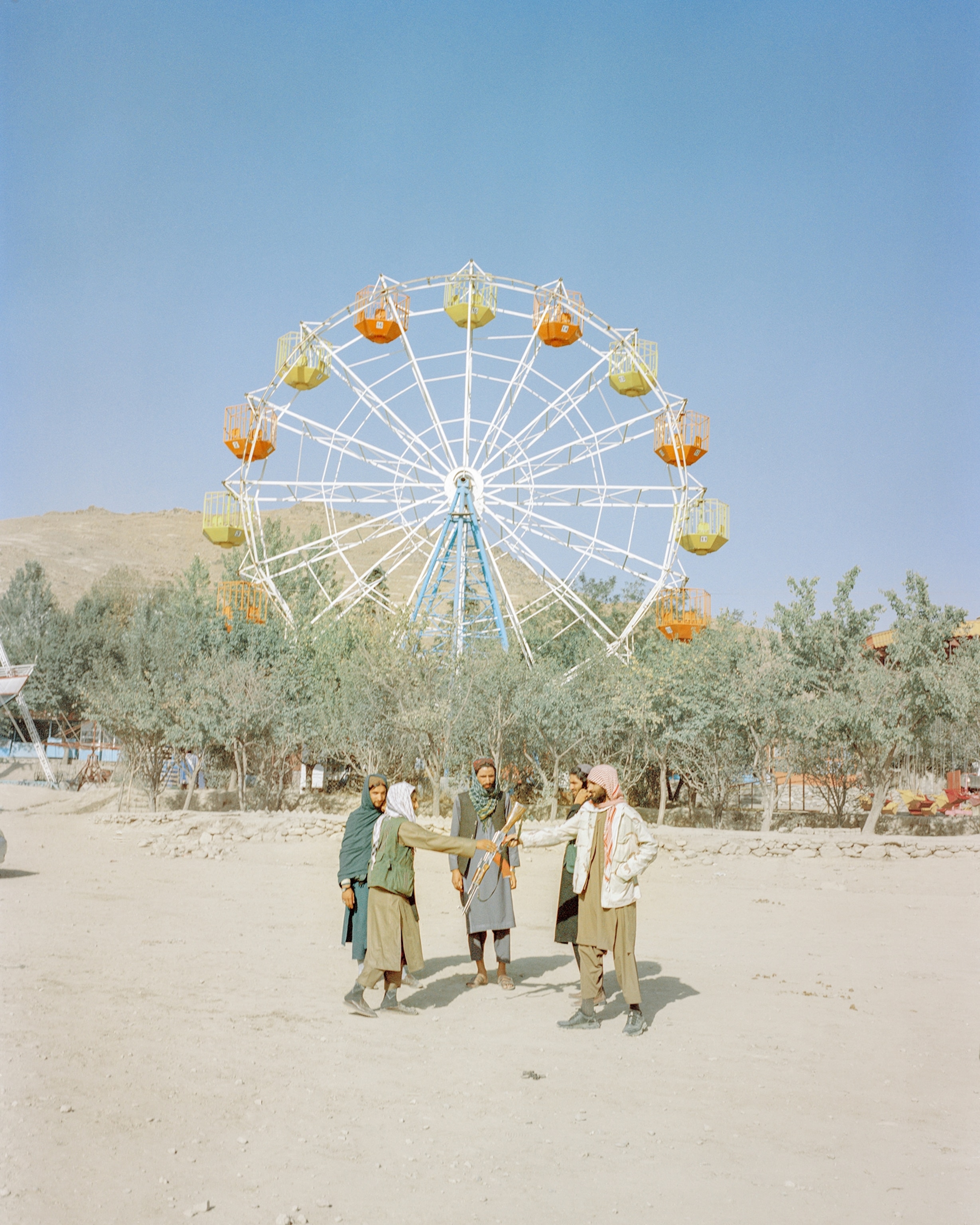 Afghanistan is a country blessed with rolling green hills, lush rivers, pristine natural dams, and gorgeous valleys. In years past, it was not unusual for families to pack an elaborate picnic basket and large quantities of tea and drive to the countryside for the weekend, where amusement parks like this one waited. While Shakeri observed that few people go to these parks now—women are banned from most public spaces—the Taliban’s fighters are a frequent sight there. He found it unusual, almost jarring, to witness armed fighters, such as this group from Wardak Province who had traveled to Kabul, trying to navigate amusement parks. As members of a militant group that spent nearly two decades engaged in battle, few of these men had a normal childhood, as most were radicalized at an early age. Even fewer are familiar with the concept of leisure.