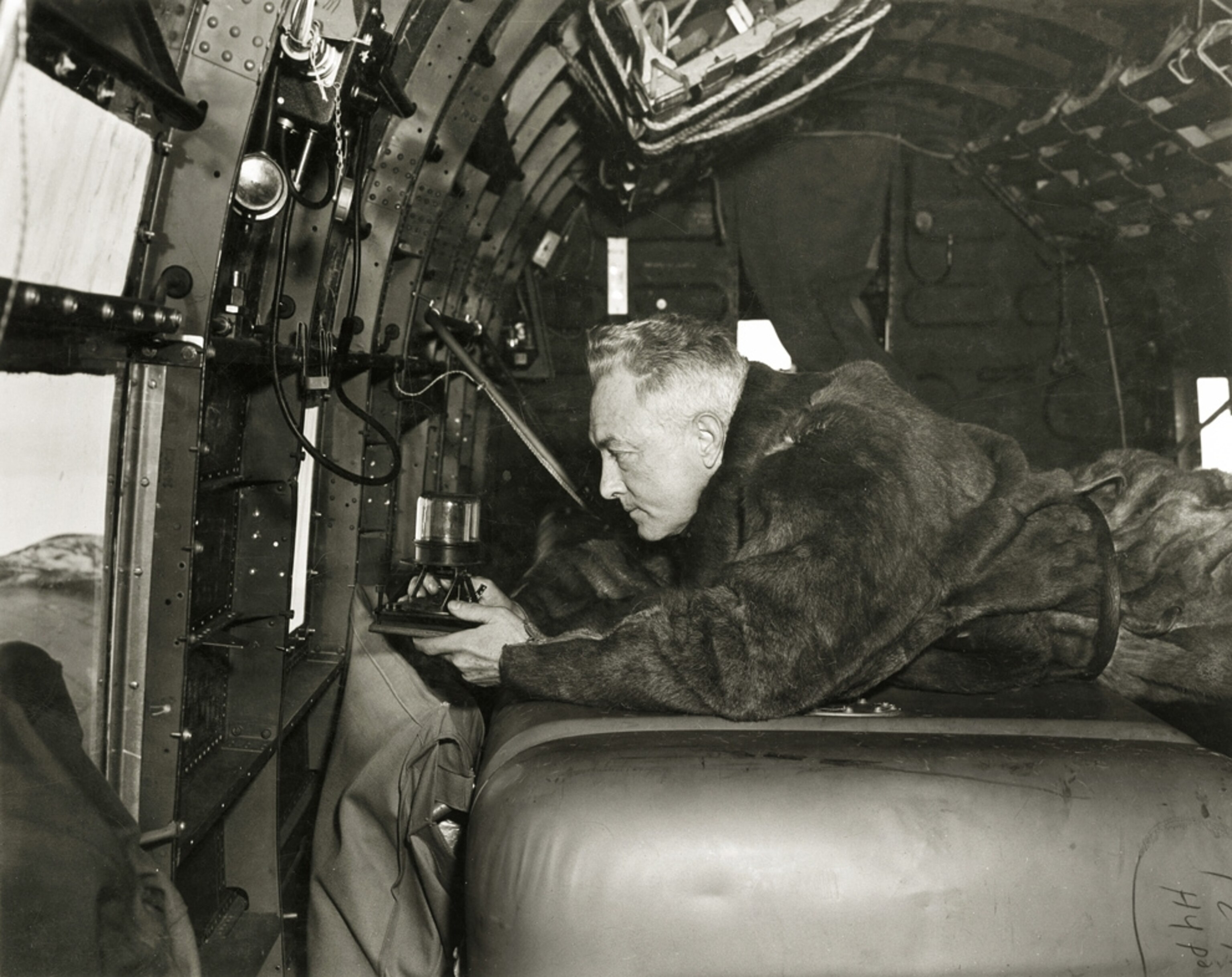 Richard Byrd picture: using compass in Antarctica during first flight over South Pole, for gallery on top ten National Geographic grants