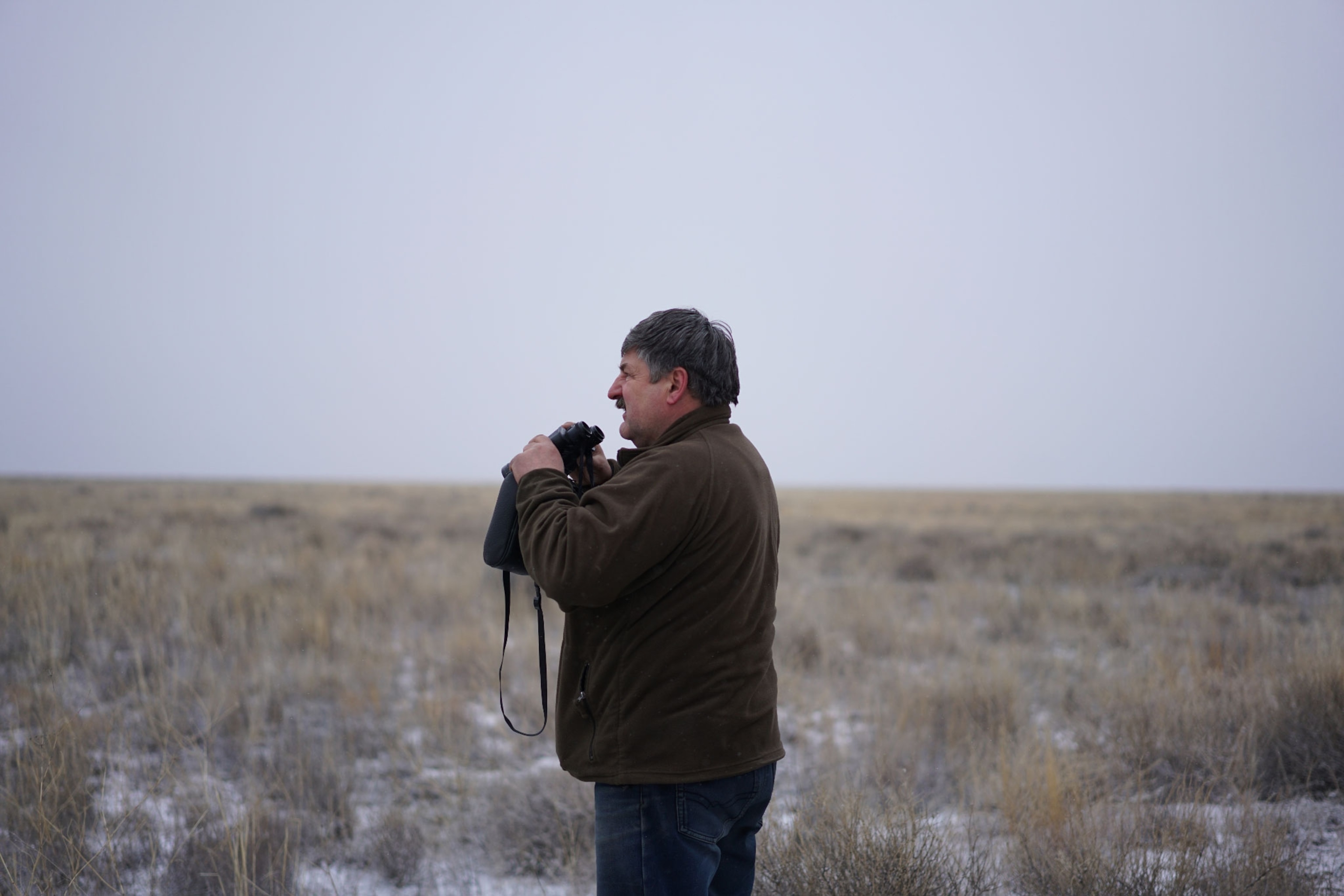 man holding binoculars
