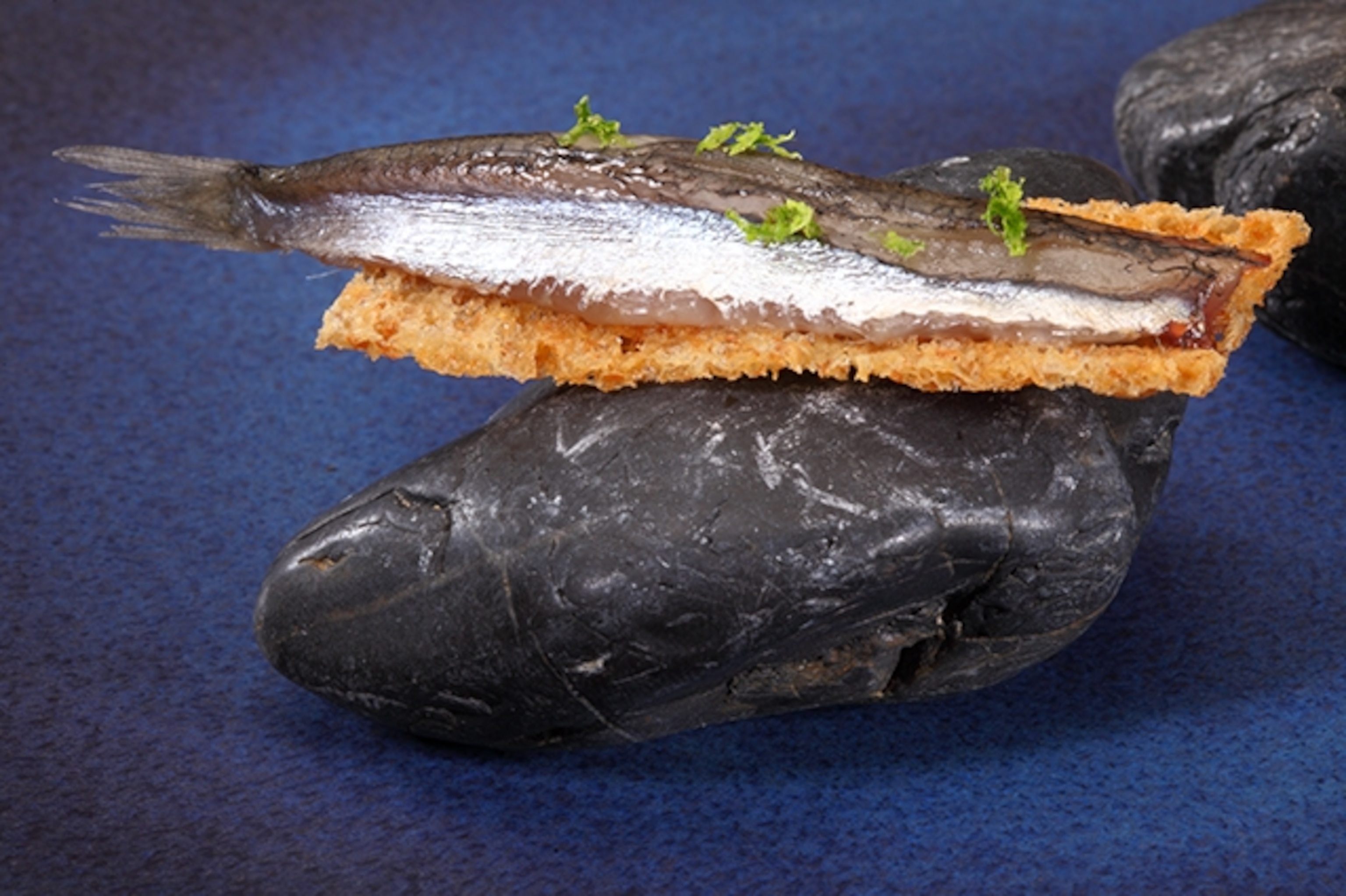 Anchovy fillets on olive bread. Photograph courtesy Lars Charas.