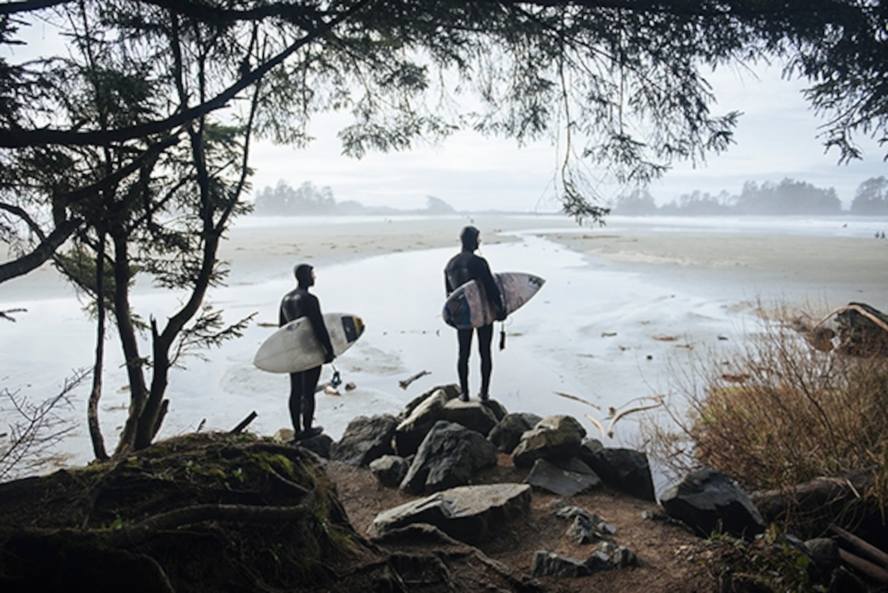 Alex Guiry and Sepp Bruhwiler scout the surf on a beach near Tofino, British Colombia. (Photograph by Max Lowe)