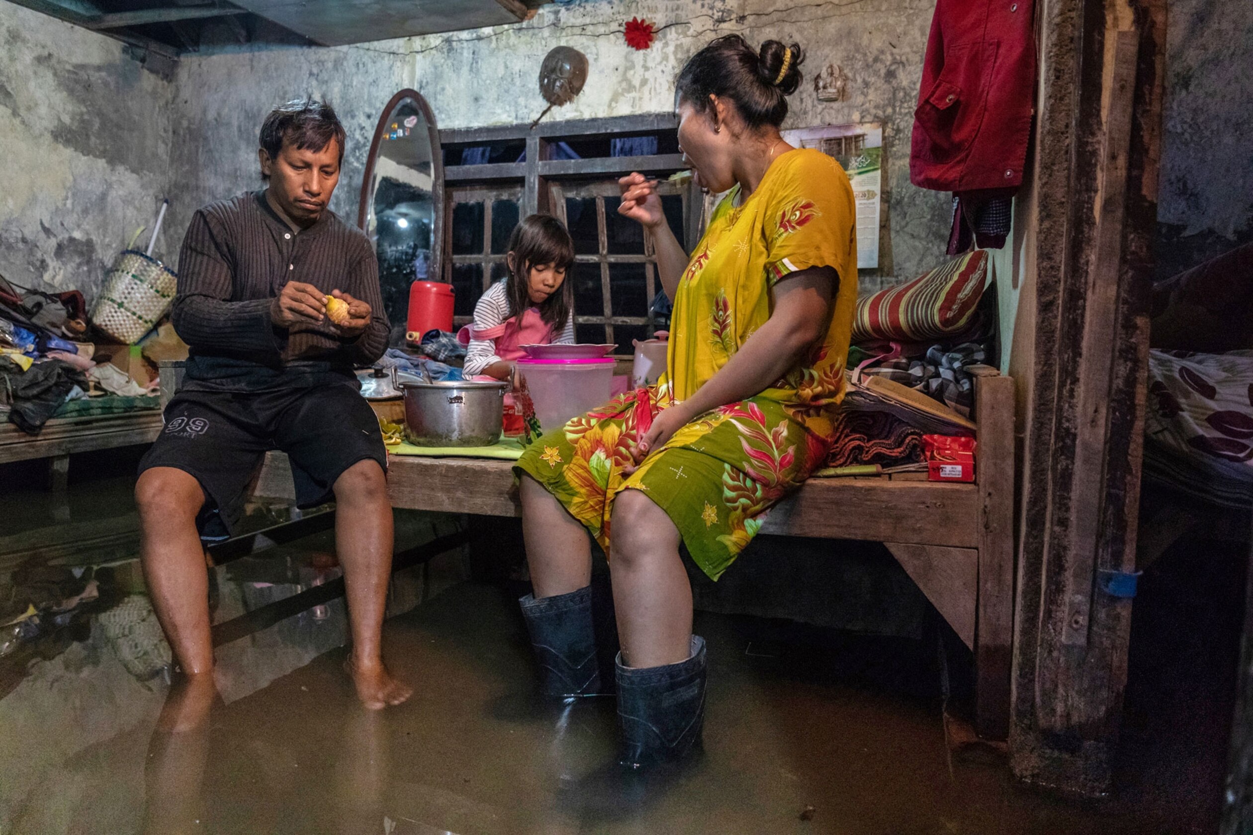 Family has dinner in flooded home in Central Java, Indonesia.