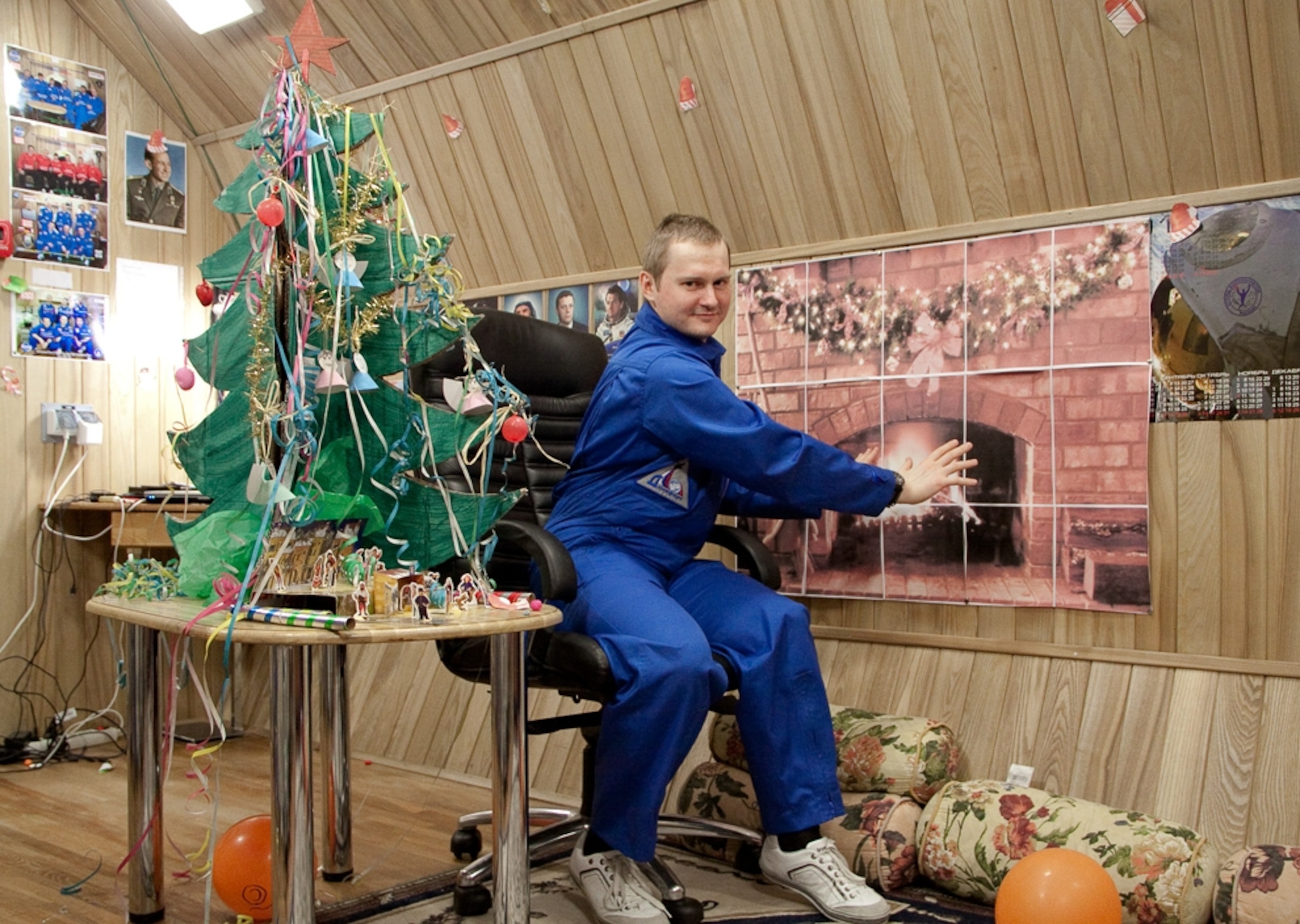 Mars500 picture: Crew member with a paper tree and fireplace