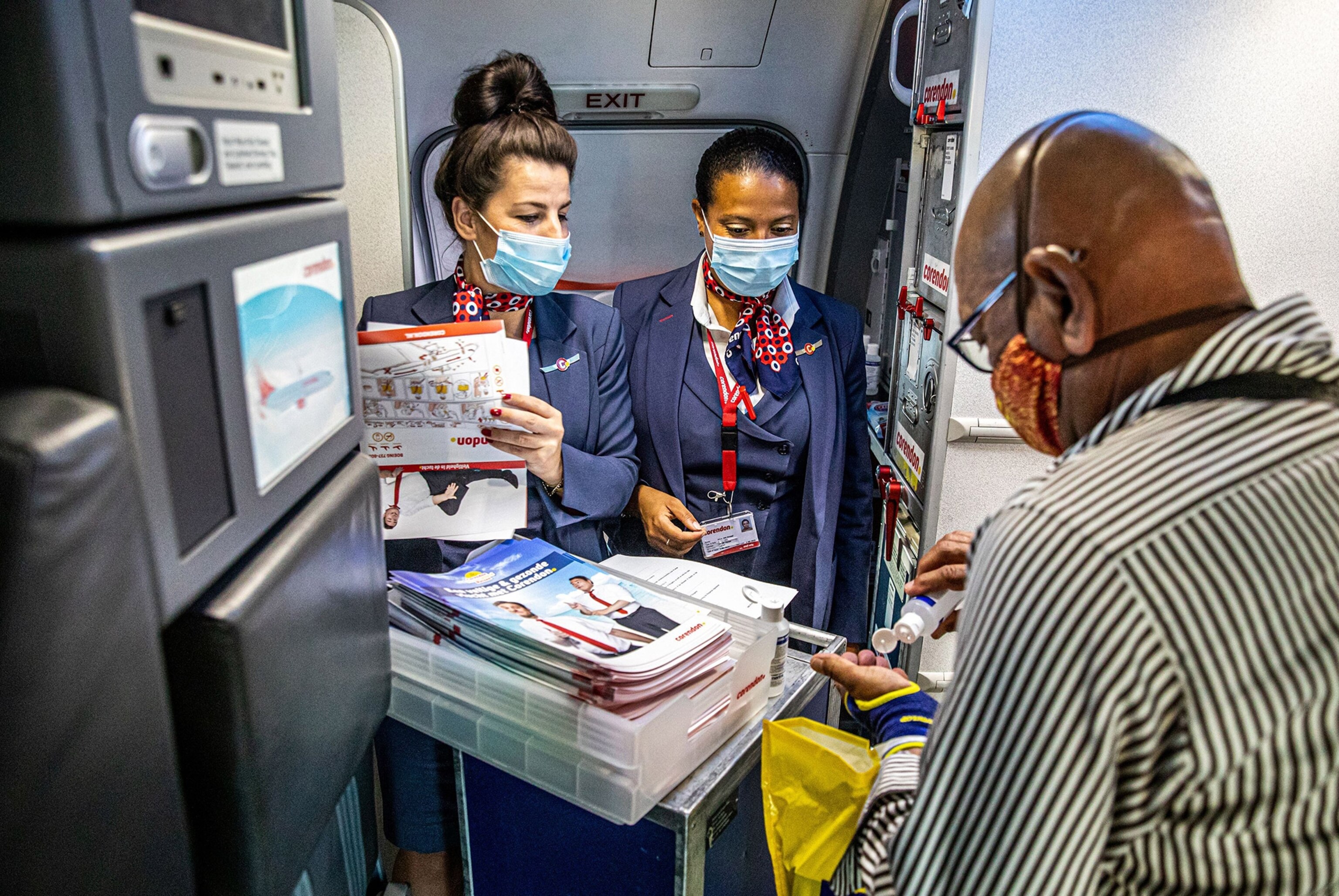 people wearing facial masks on a flight