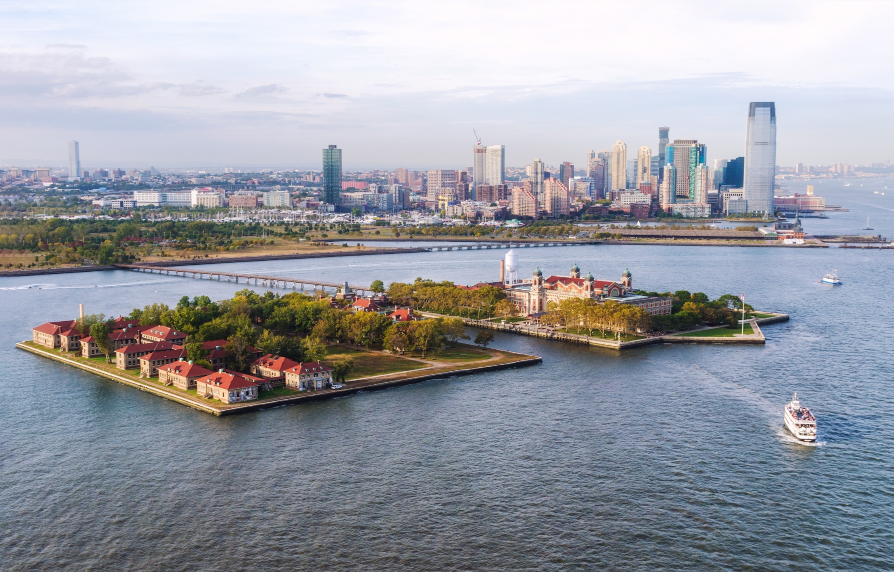 Aerial view of a ferry leaving Ellis Island and Jersey city. USA