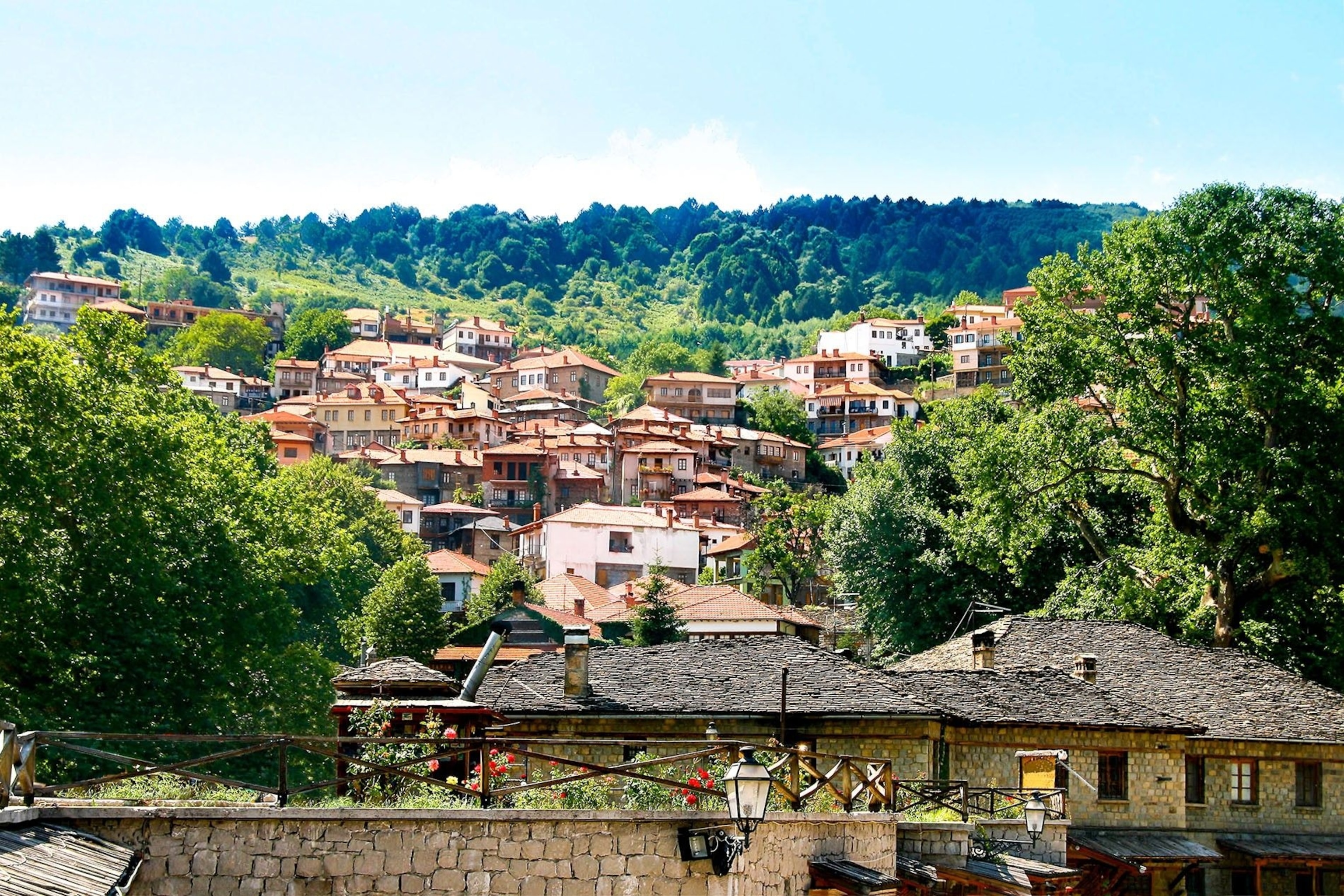 Glinavos, a small town. It is on a hill, so rows of houses appear above head height, higher and higher until they disappear into dense forest.