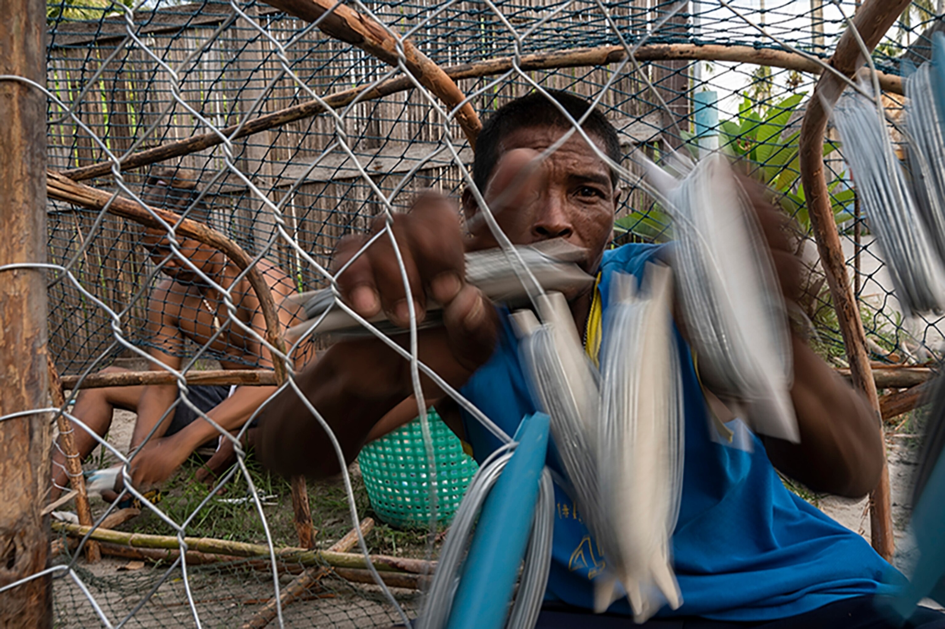 Image of Urak Lawoi fixing up traditional fishing trap.