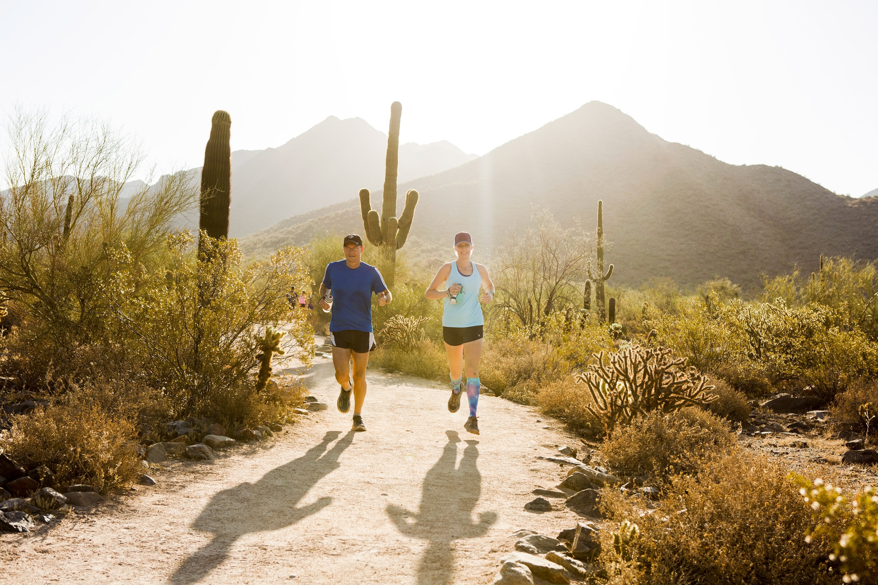 a couple running the Gateway Loop trail in Scottsdale, Arizona