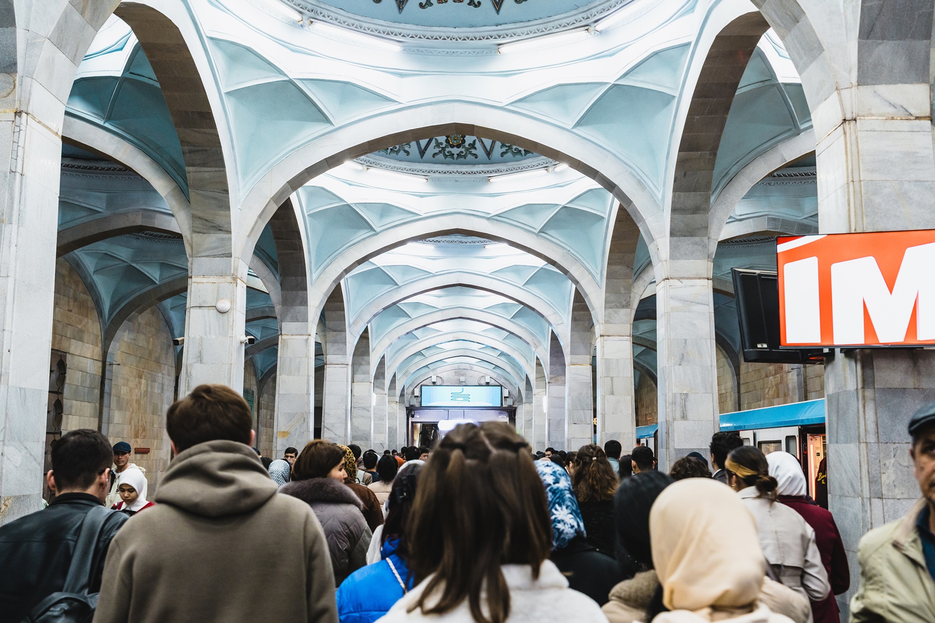 A futuristic train station with an arched, diamond-shaped ceiling.