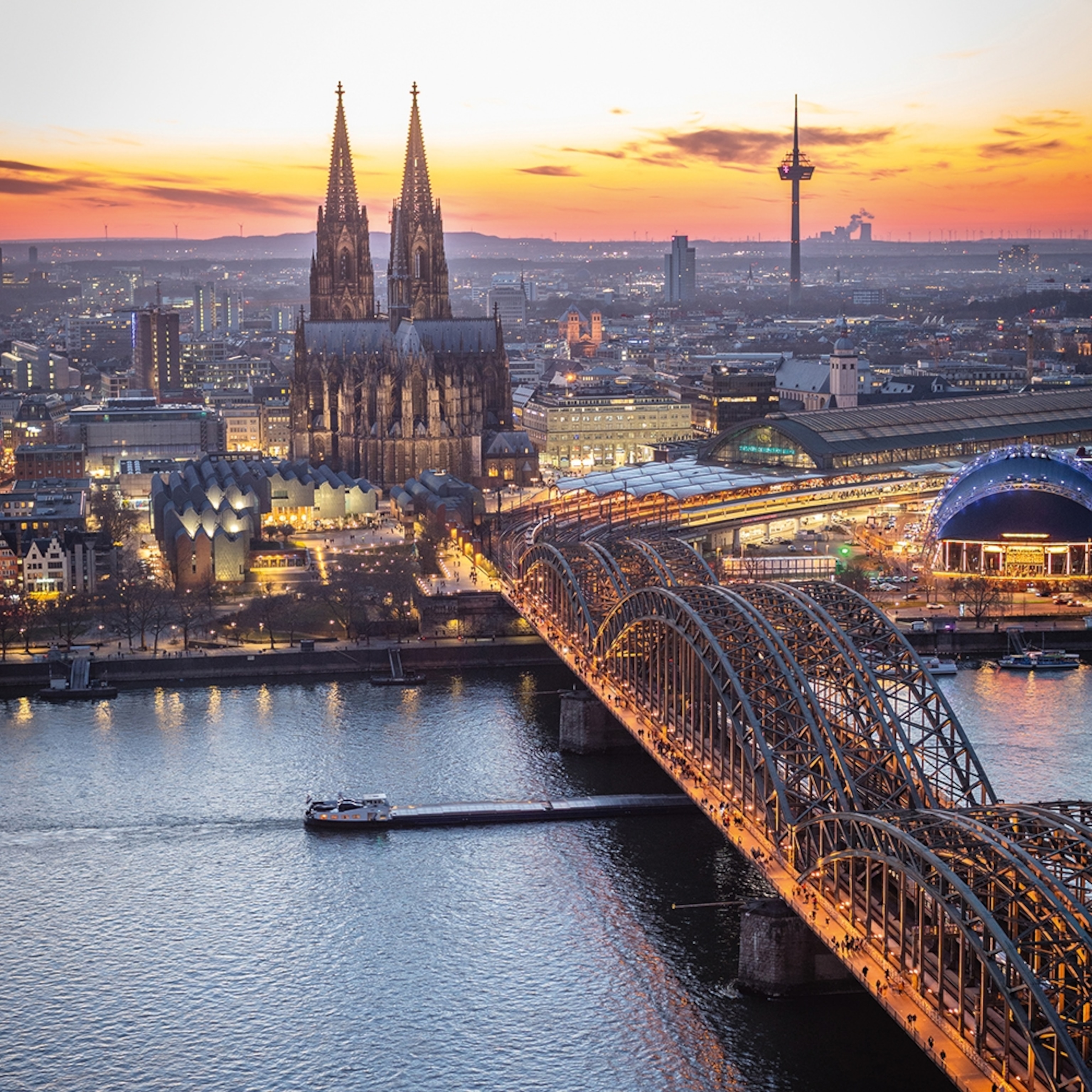 The Cologne skyline featuring the cathedral and the Hohenzollern railway bridge.