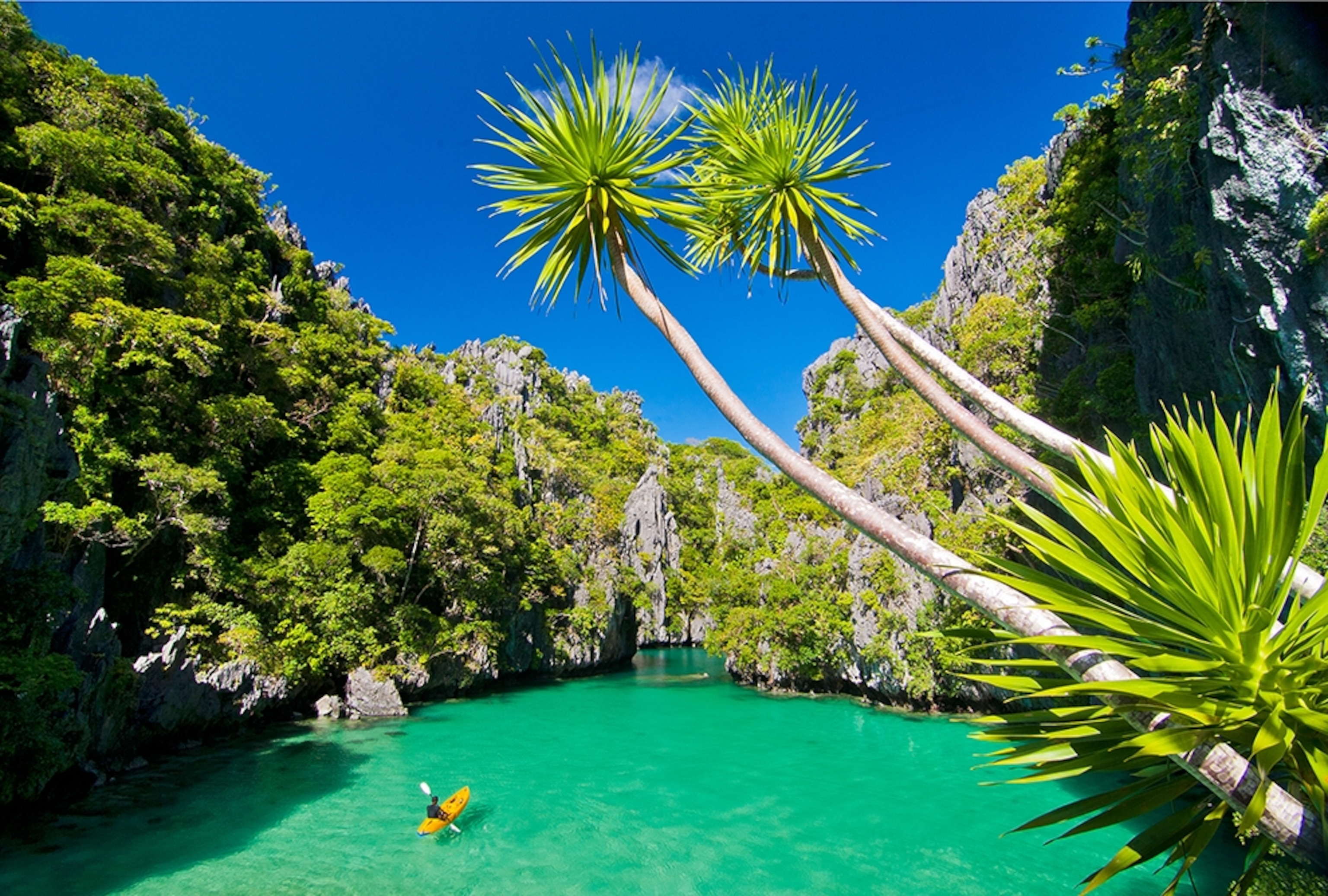 a kayaker paddling in a lagoon in El Nido, Palawan, Philippines