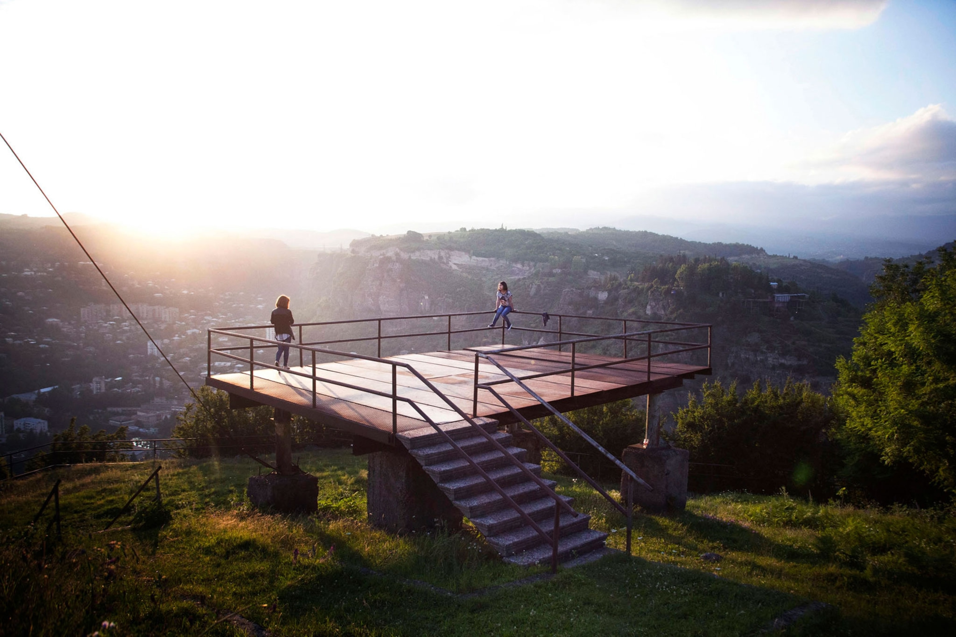 two sisters playing on an elevated concrete platform in Chiatura, Georgia