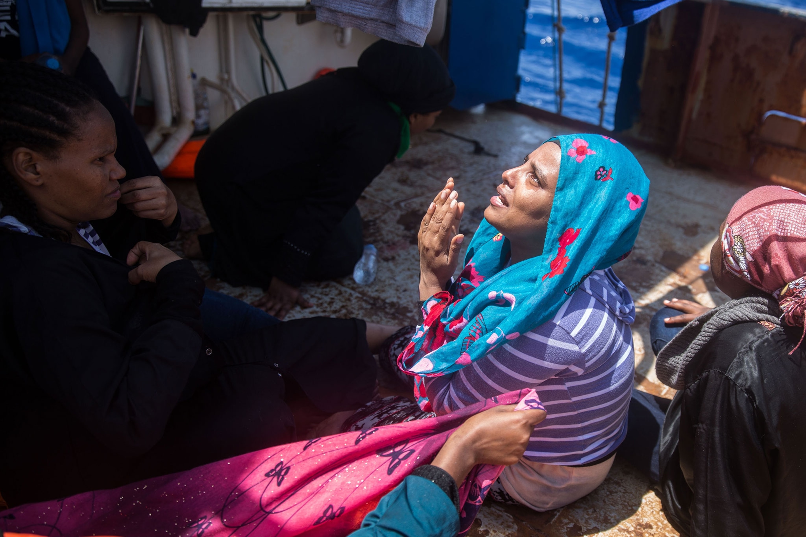 a woman on a ship praying