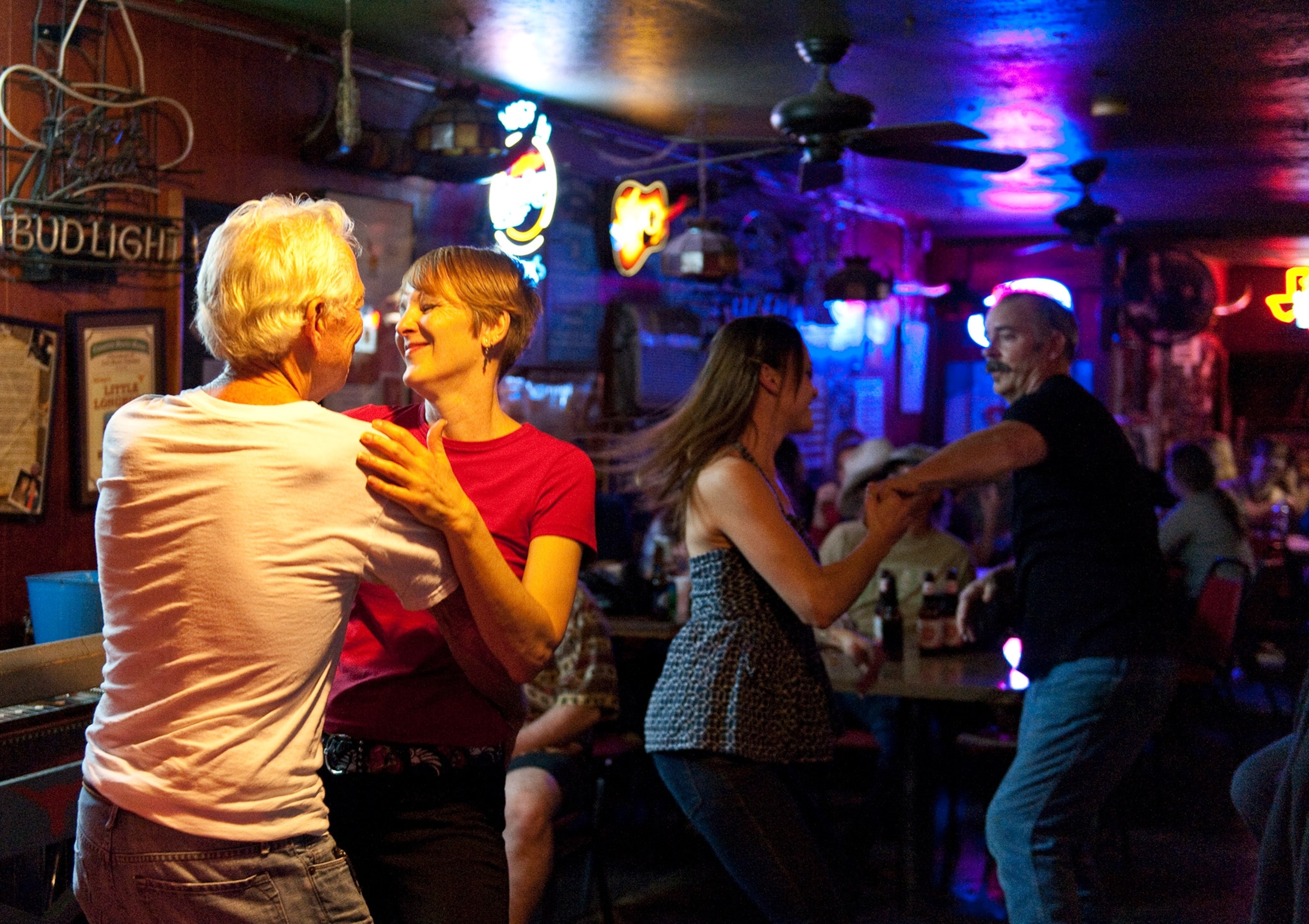 people dancing in The Little Longhorn Saloon, a honky tonk in Austin, Texas