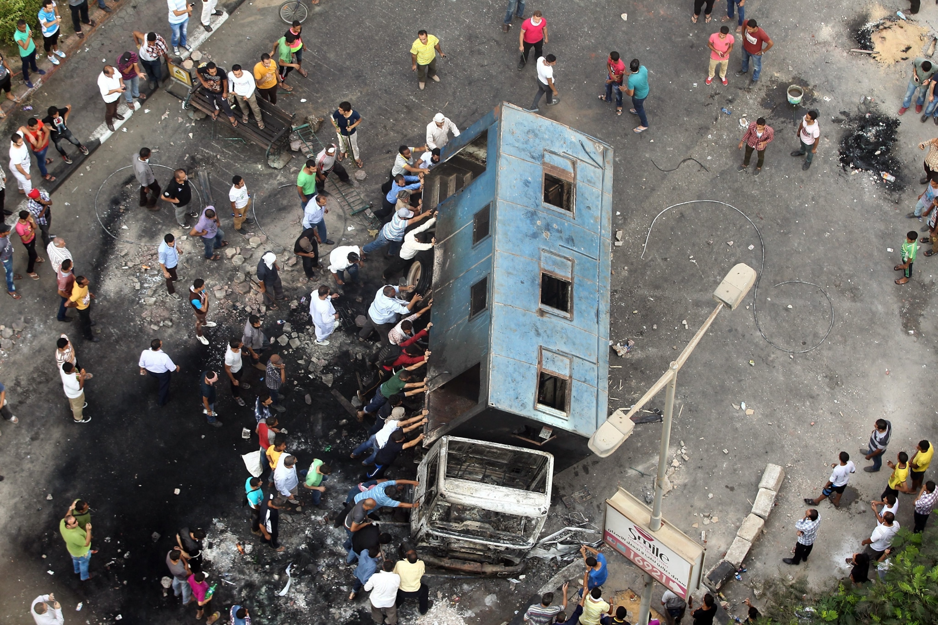 Morsi supporters topple a truck.