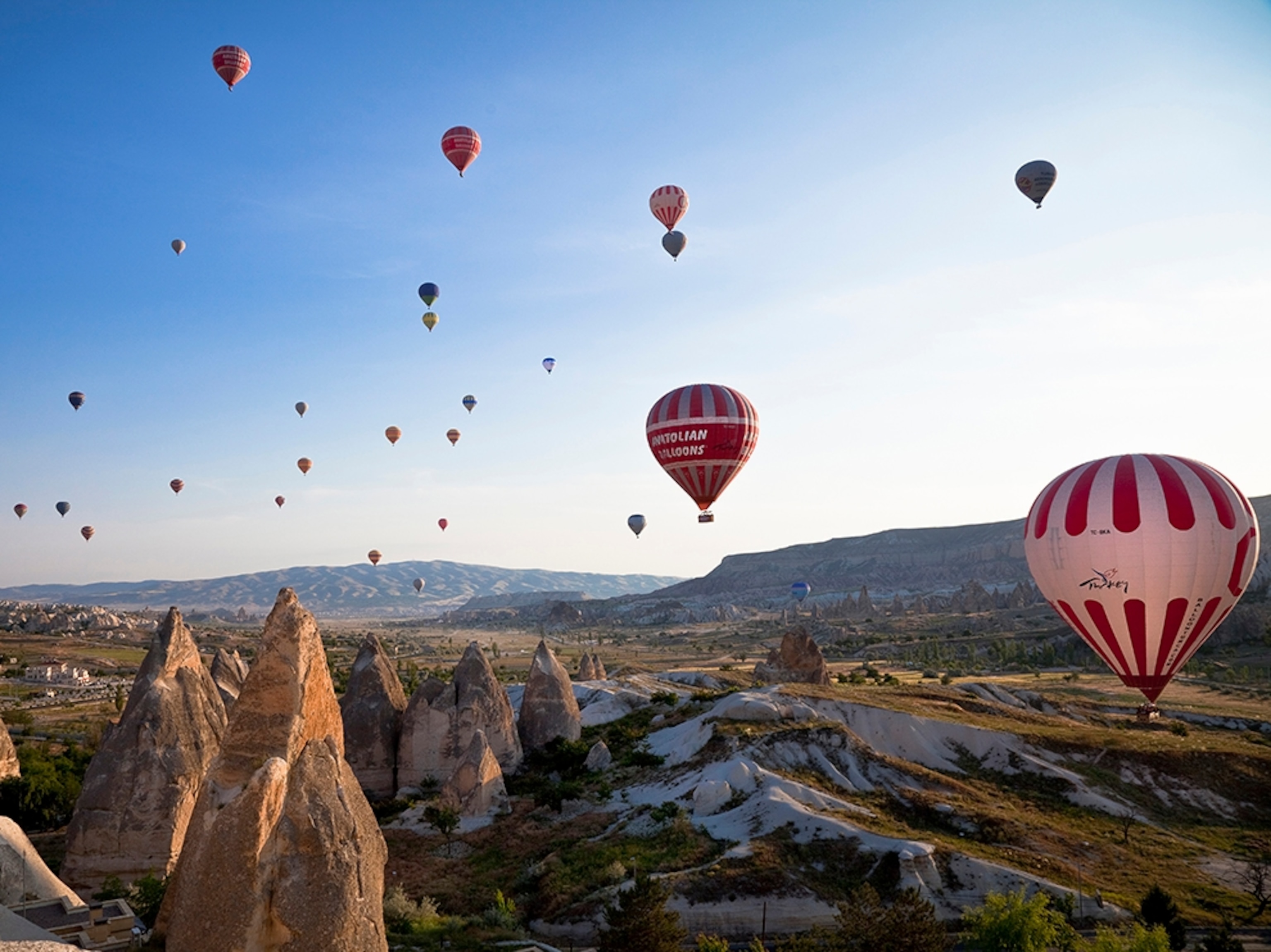 hot air balloons rising over Cappadocia, Turkey