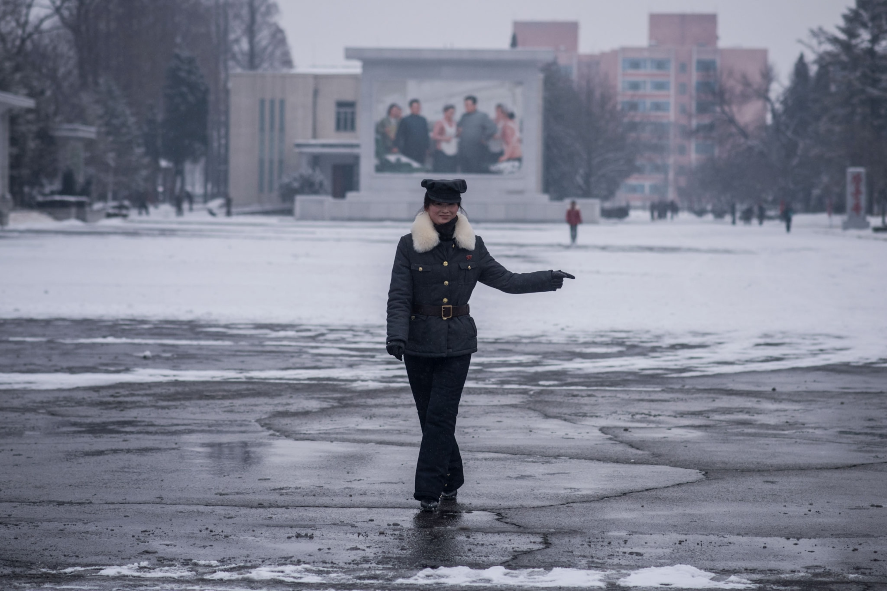 a woman directing traffic in North Korea