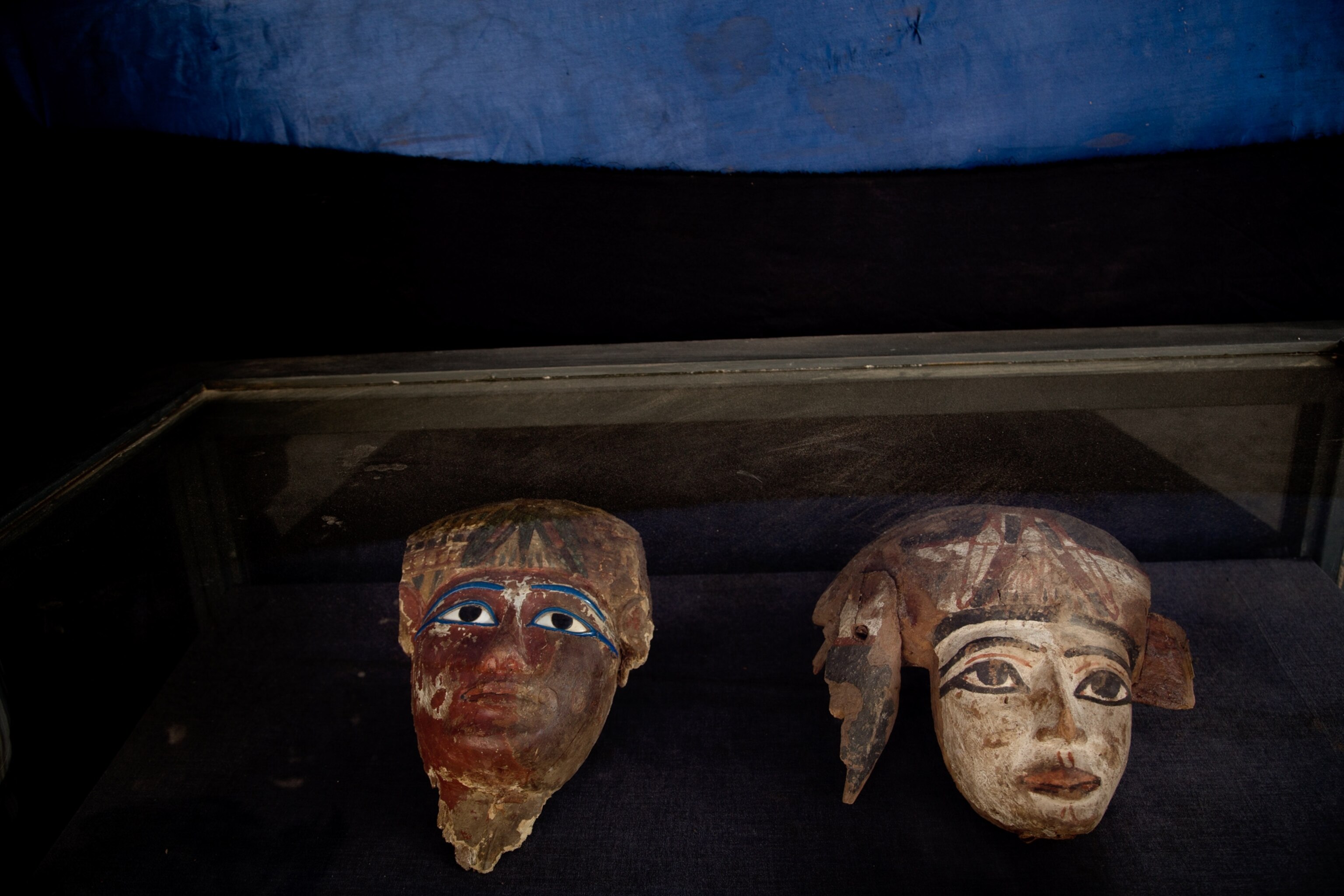 Painted wooden funerary masks in newly discovered tomb on Luxor's West Bank in Egypt