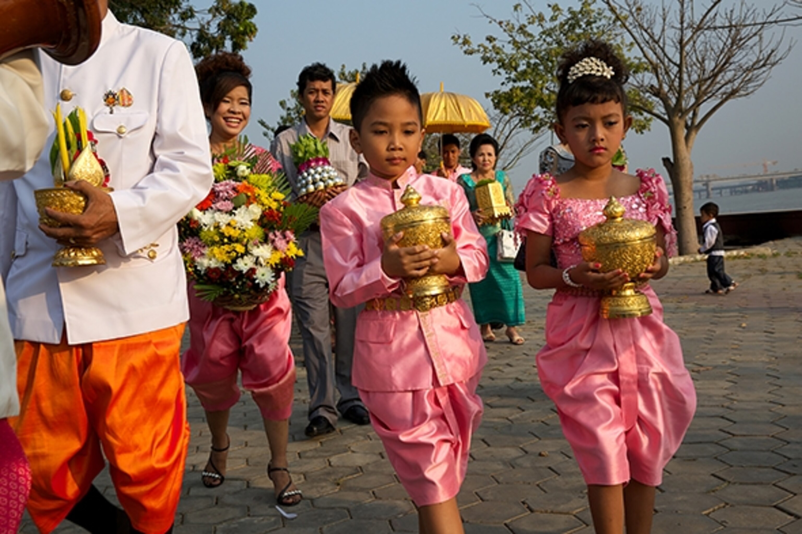 A wedding procession makes its way along the Tonle Sap riverfront. (Photograph by Palani Mohan)