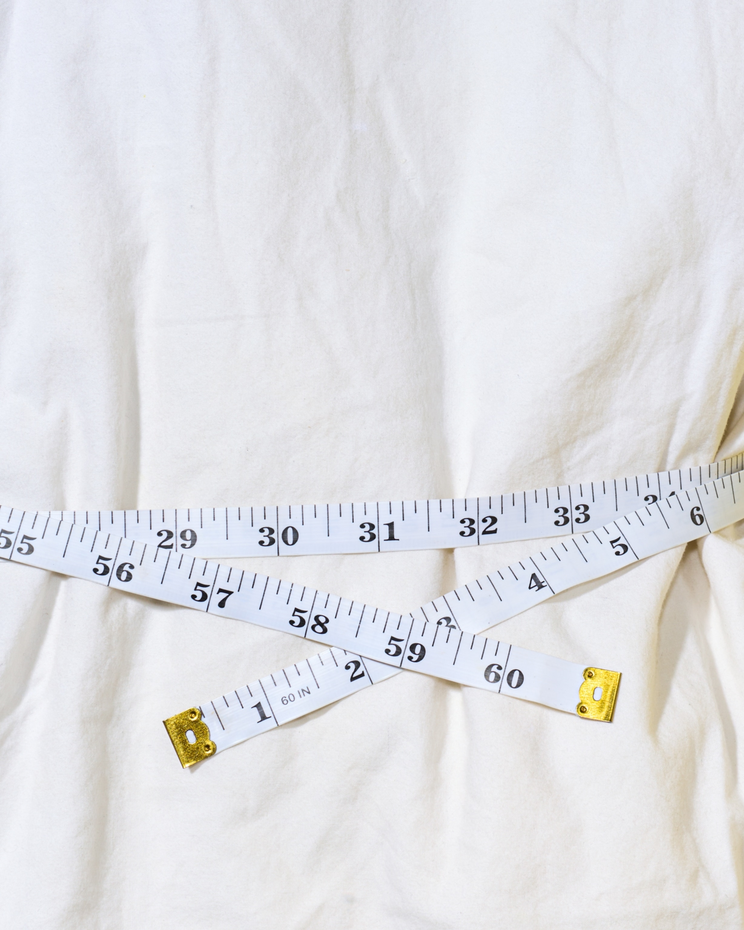 Measuring tape cinched around a pillow.