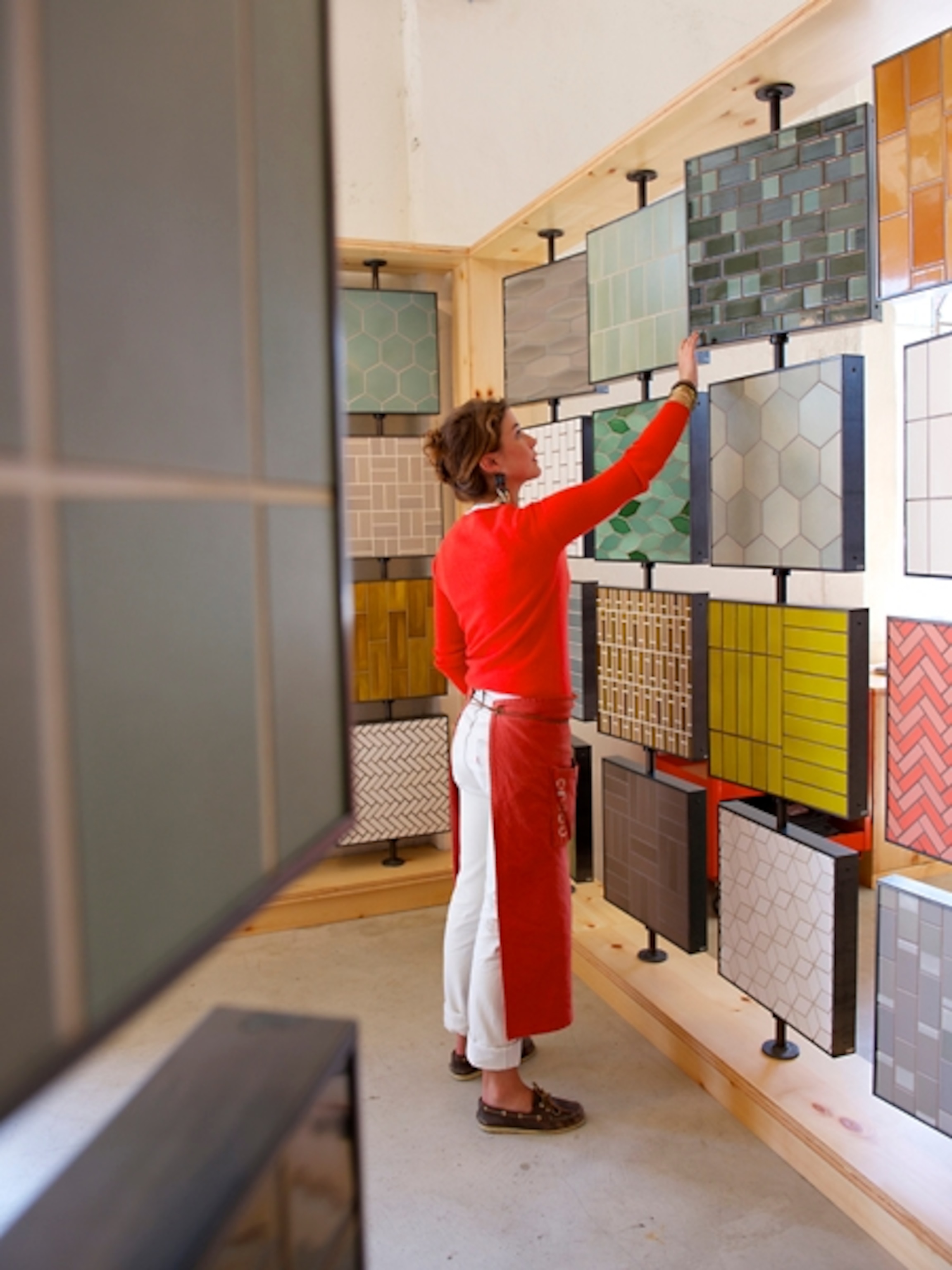 an employee arranging tiles at Heath Ceramics