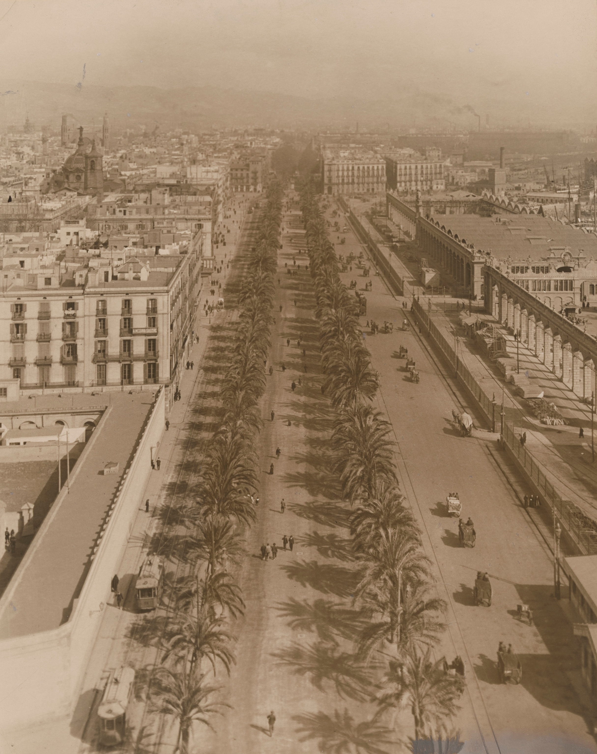 People walk along the Paseo de Colón.
