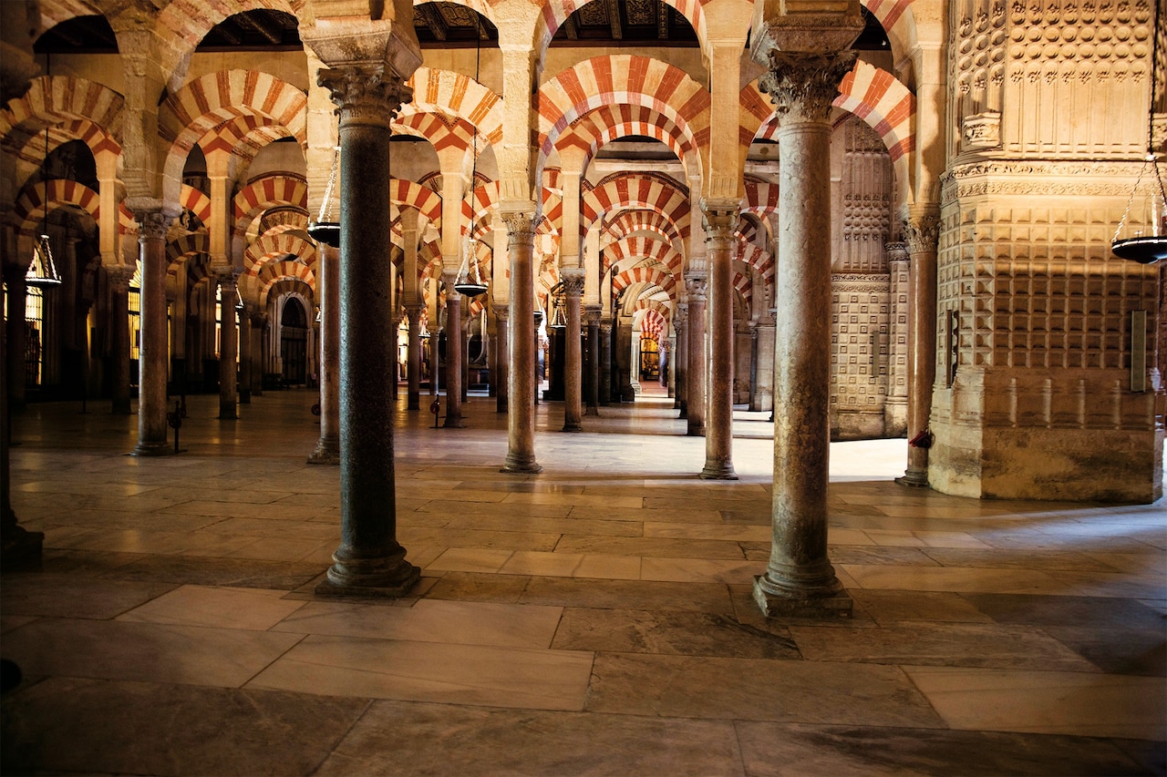 The Córdoba mosque was expanded several times by Muslim rulers. The vast colonnaded area appears larger than it is, as the repeating patterns creates an illusion of infinite space.