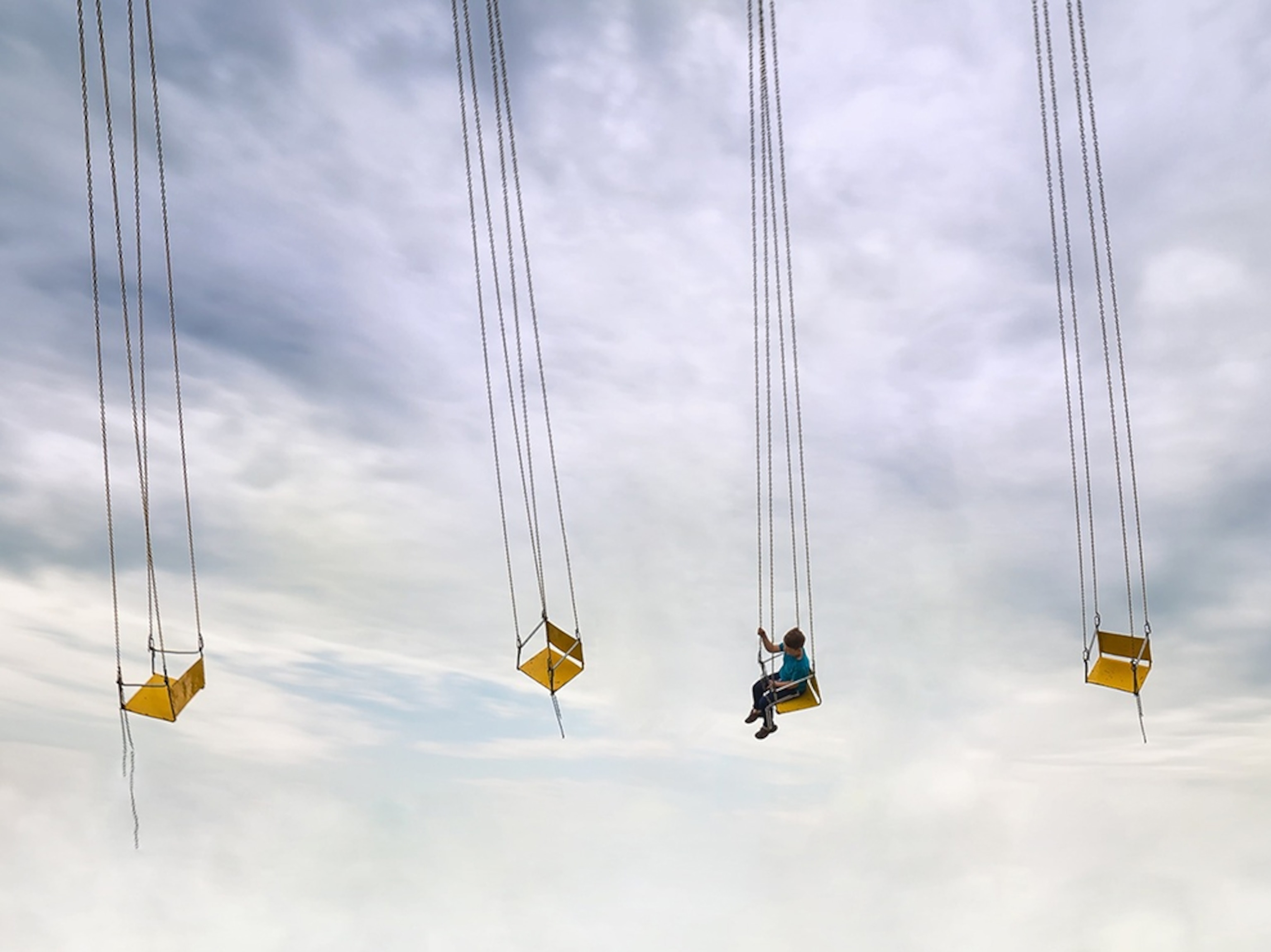 a child on a fair swing in Horezu, Romania