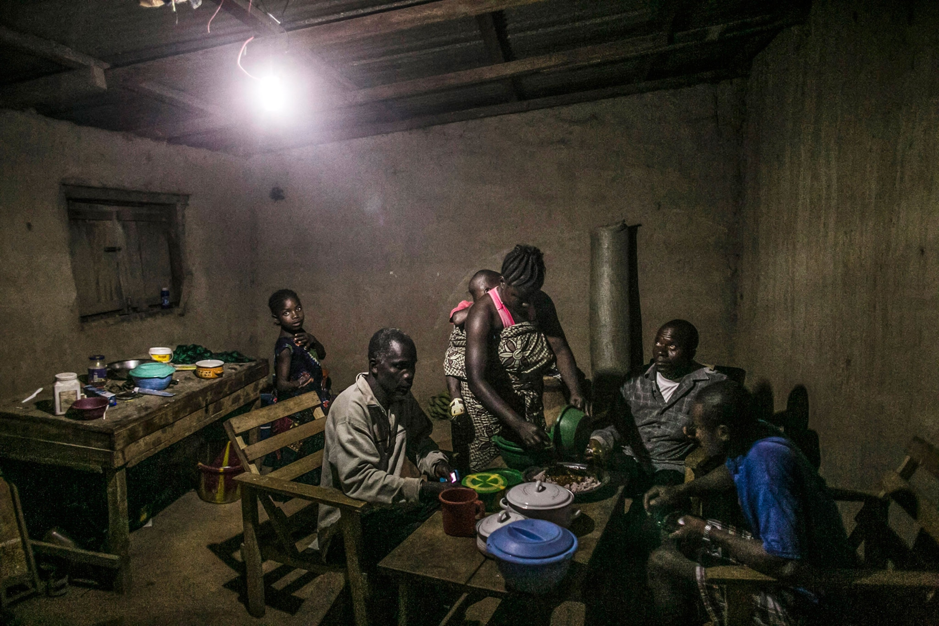 adults inside a room eating dinner together