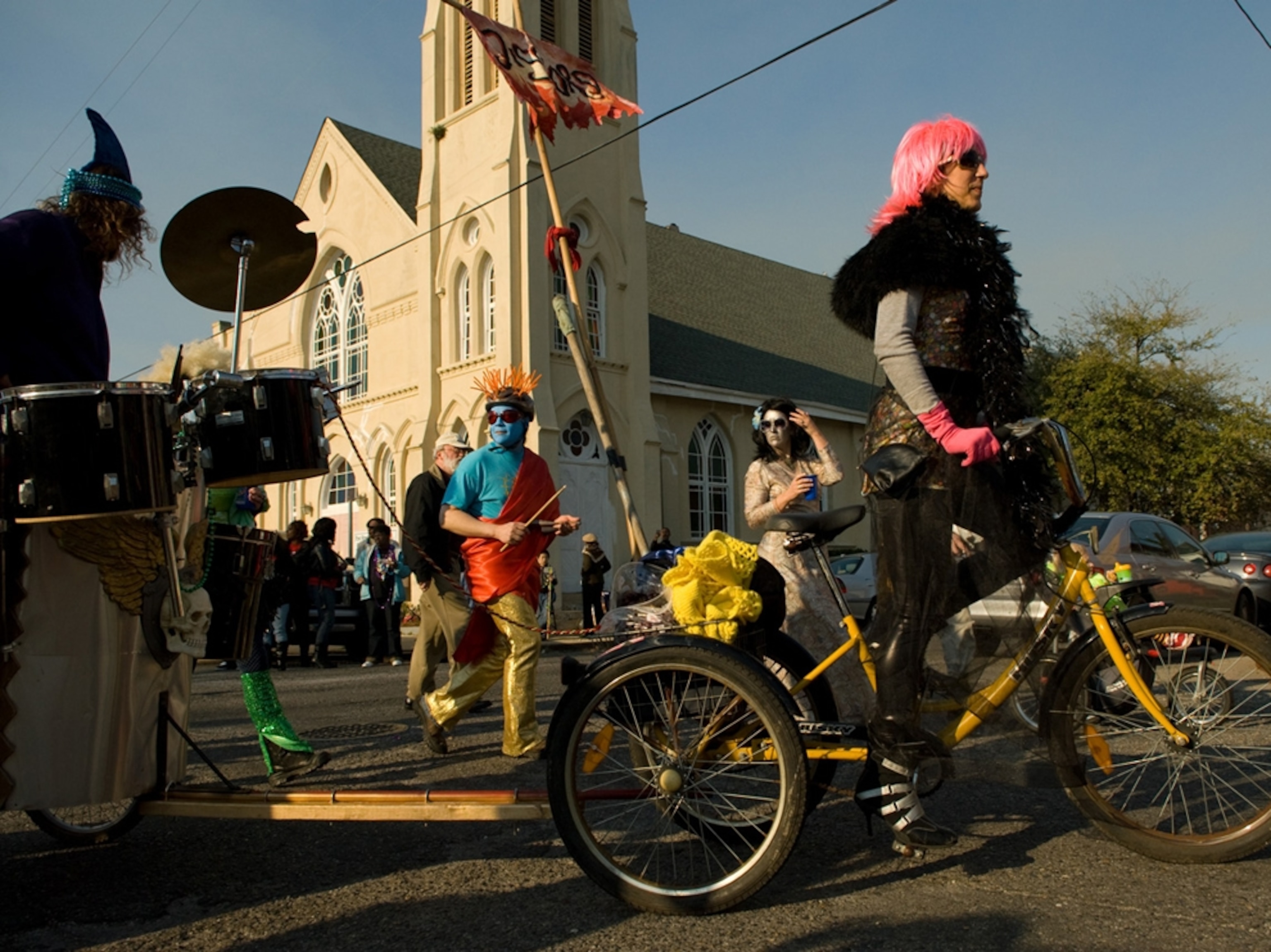 Woman rides bike in Mardi Gras parade, New Orleans