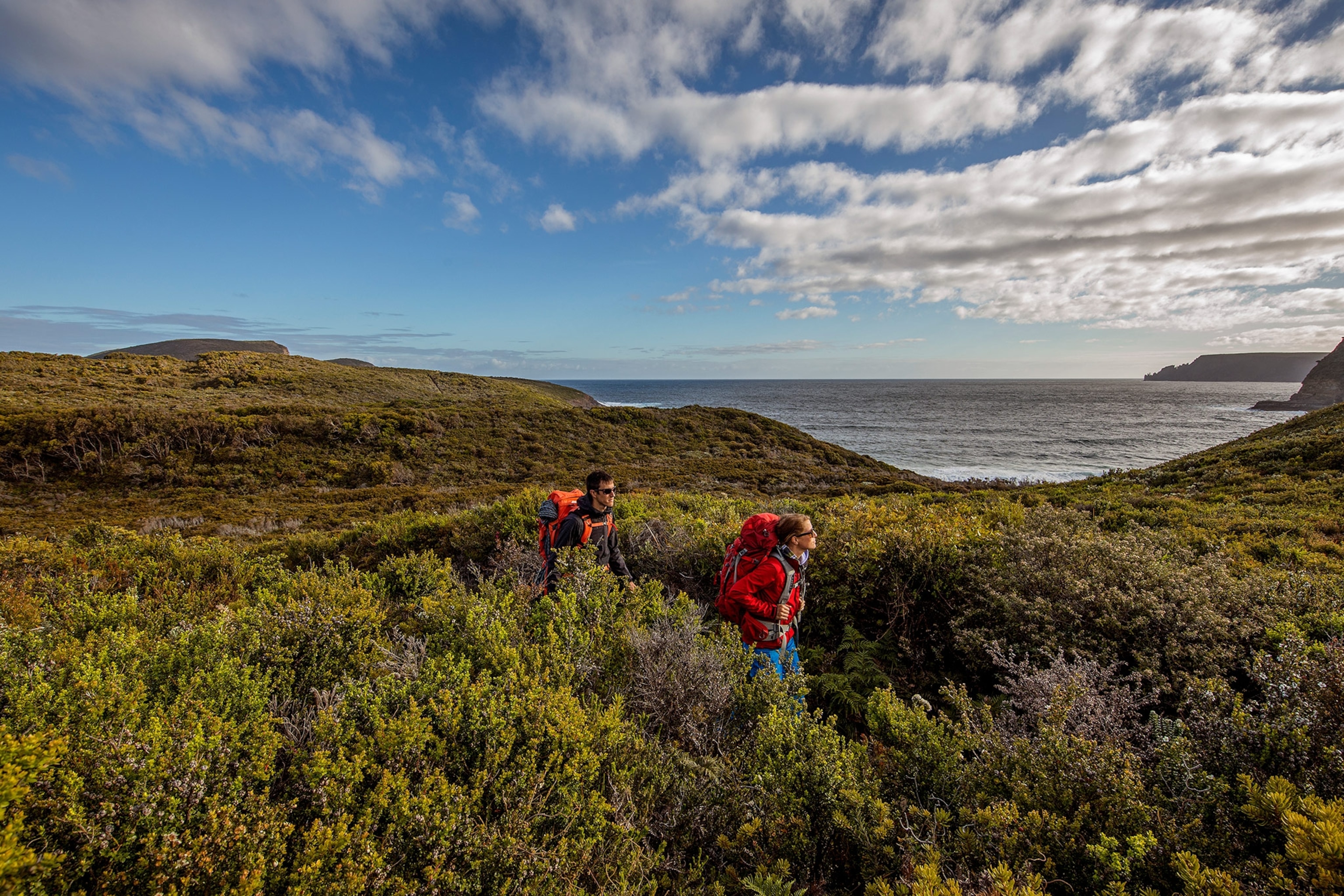 two hikers coming from Mount Brown in the Tasman National Park in Tasmania
