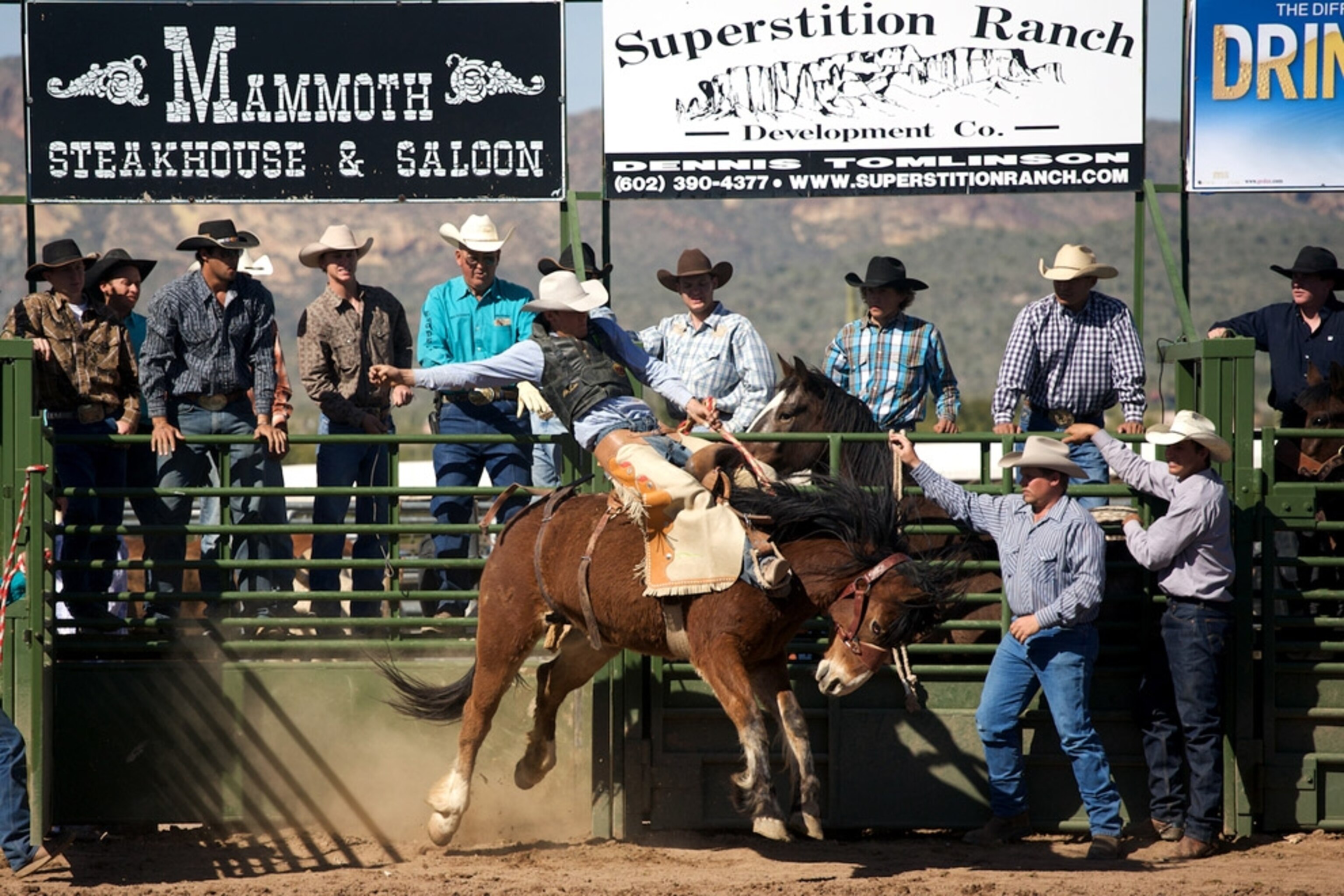 Rodeo participants at an arena gate