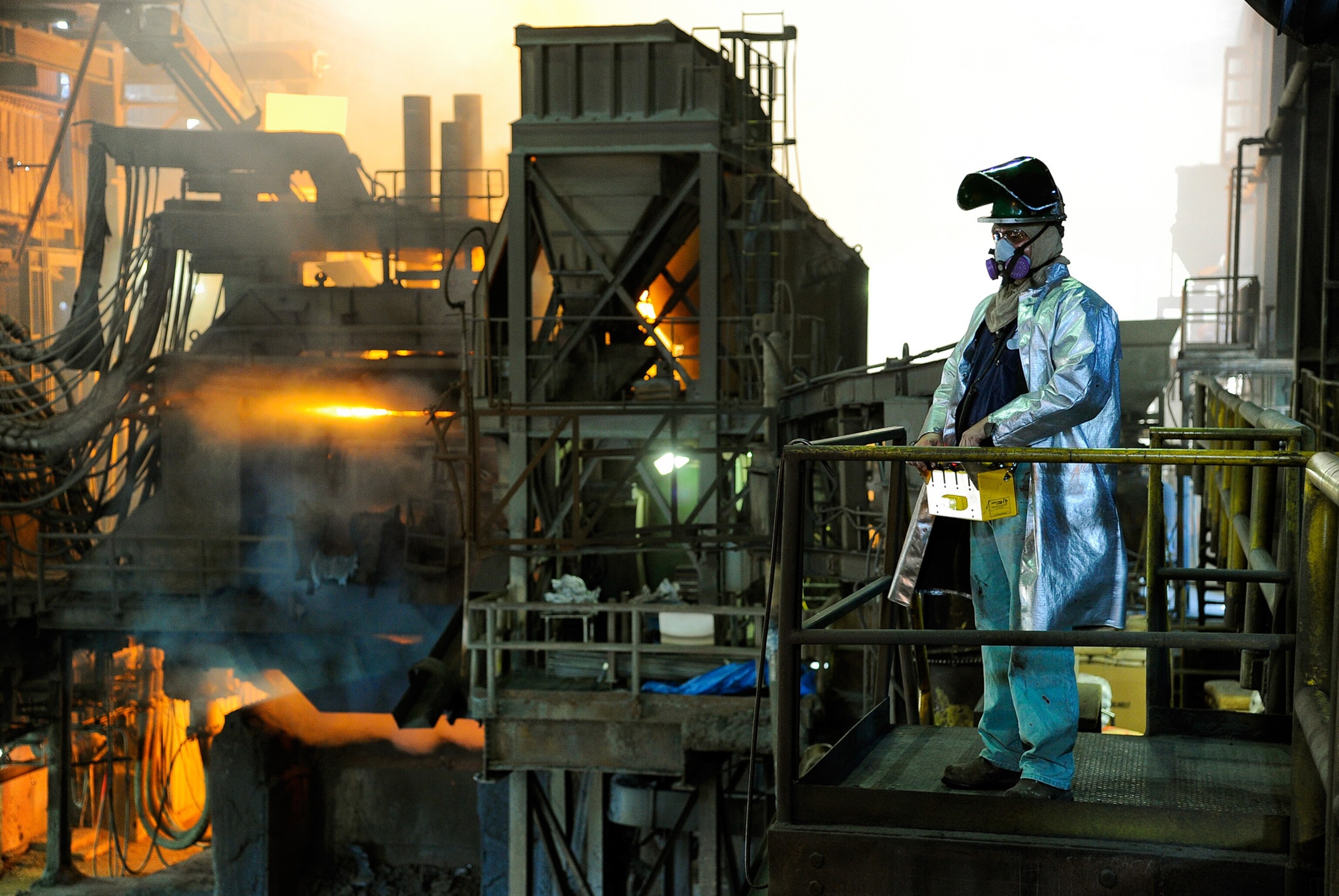 Jerry McKinney operating a crane by remote control near the huge electric furnace.