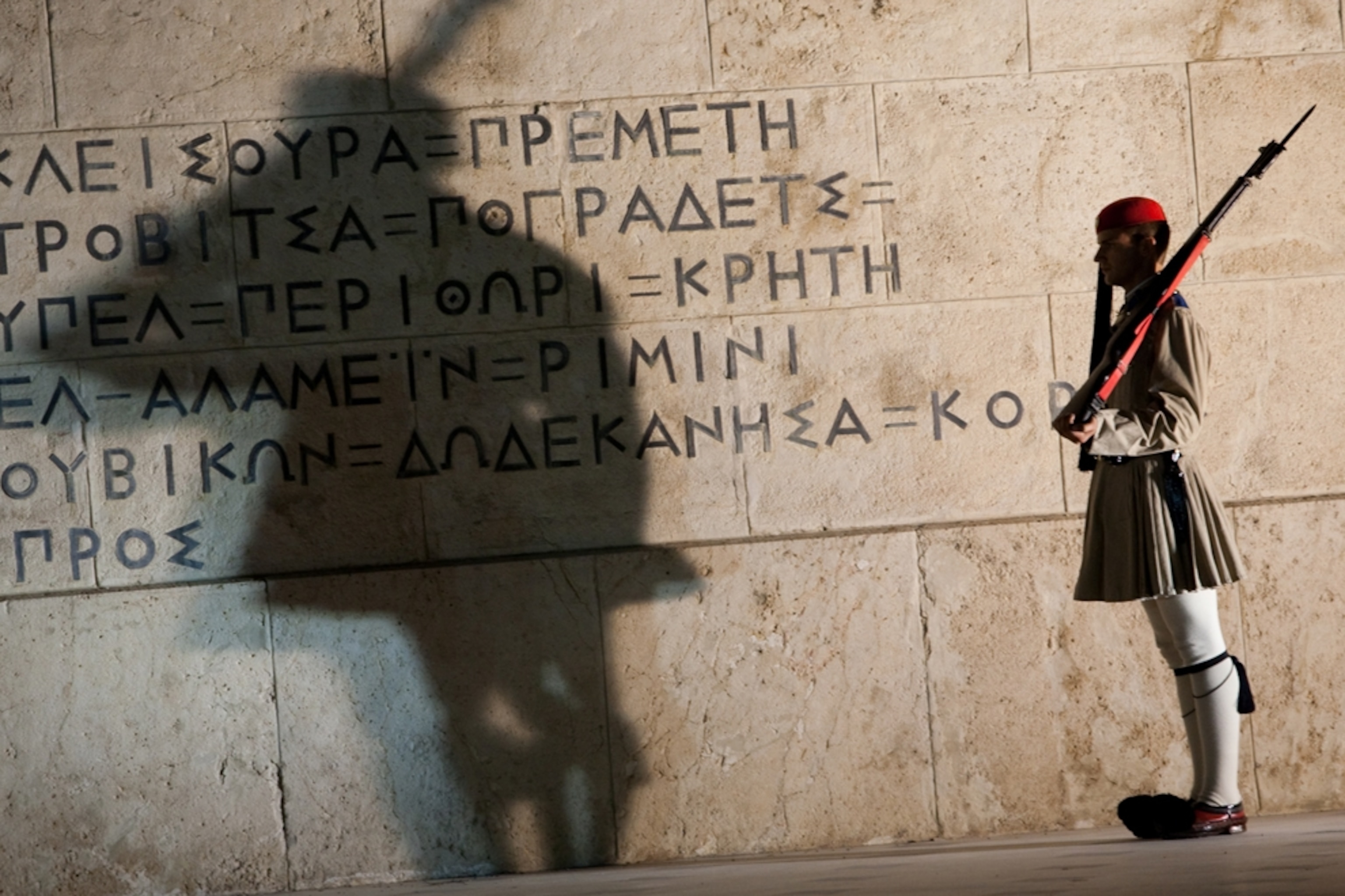 Soldier standing in front of a wall in Greece