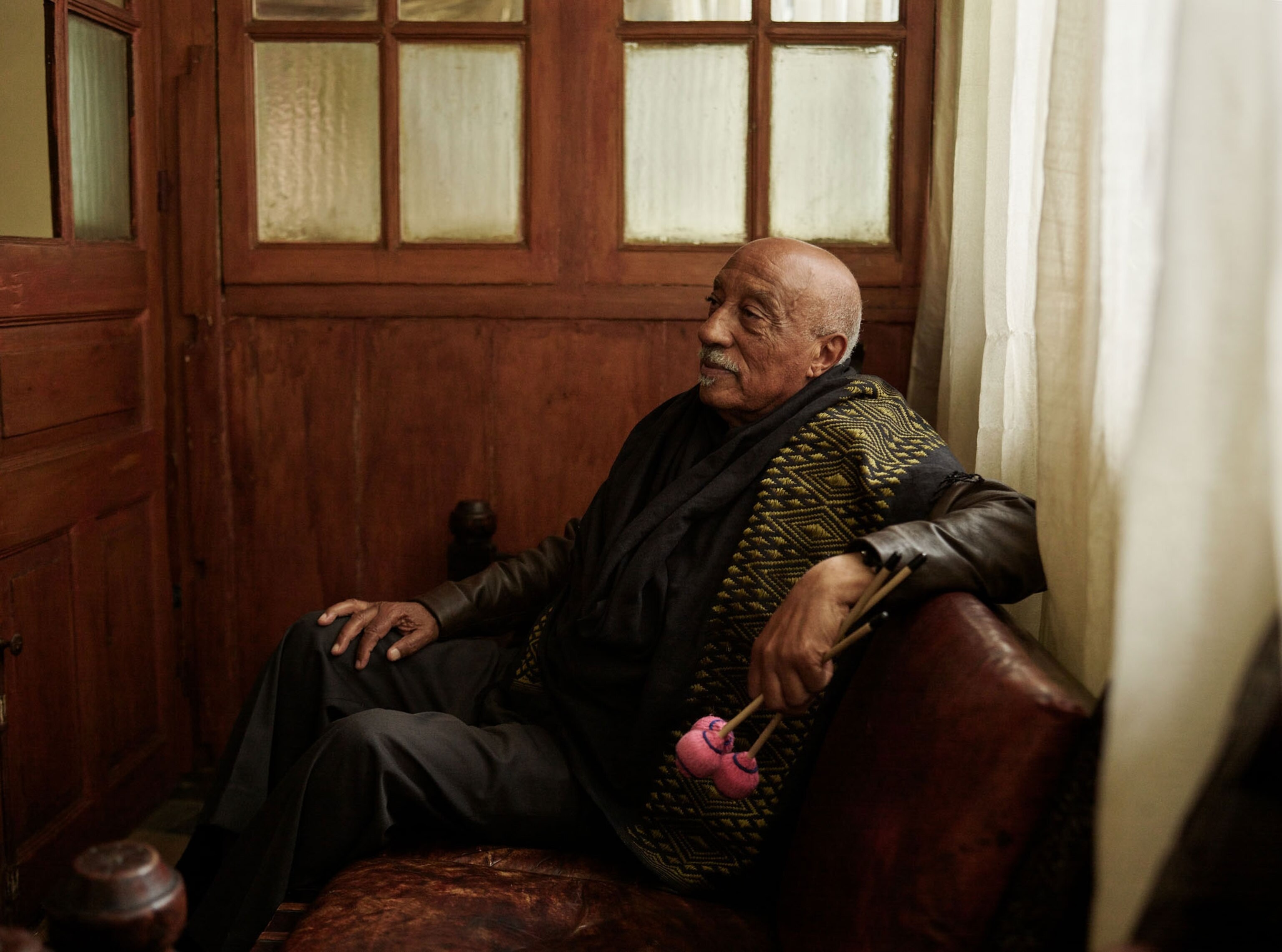 A man sits and is photographed from his profile