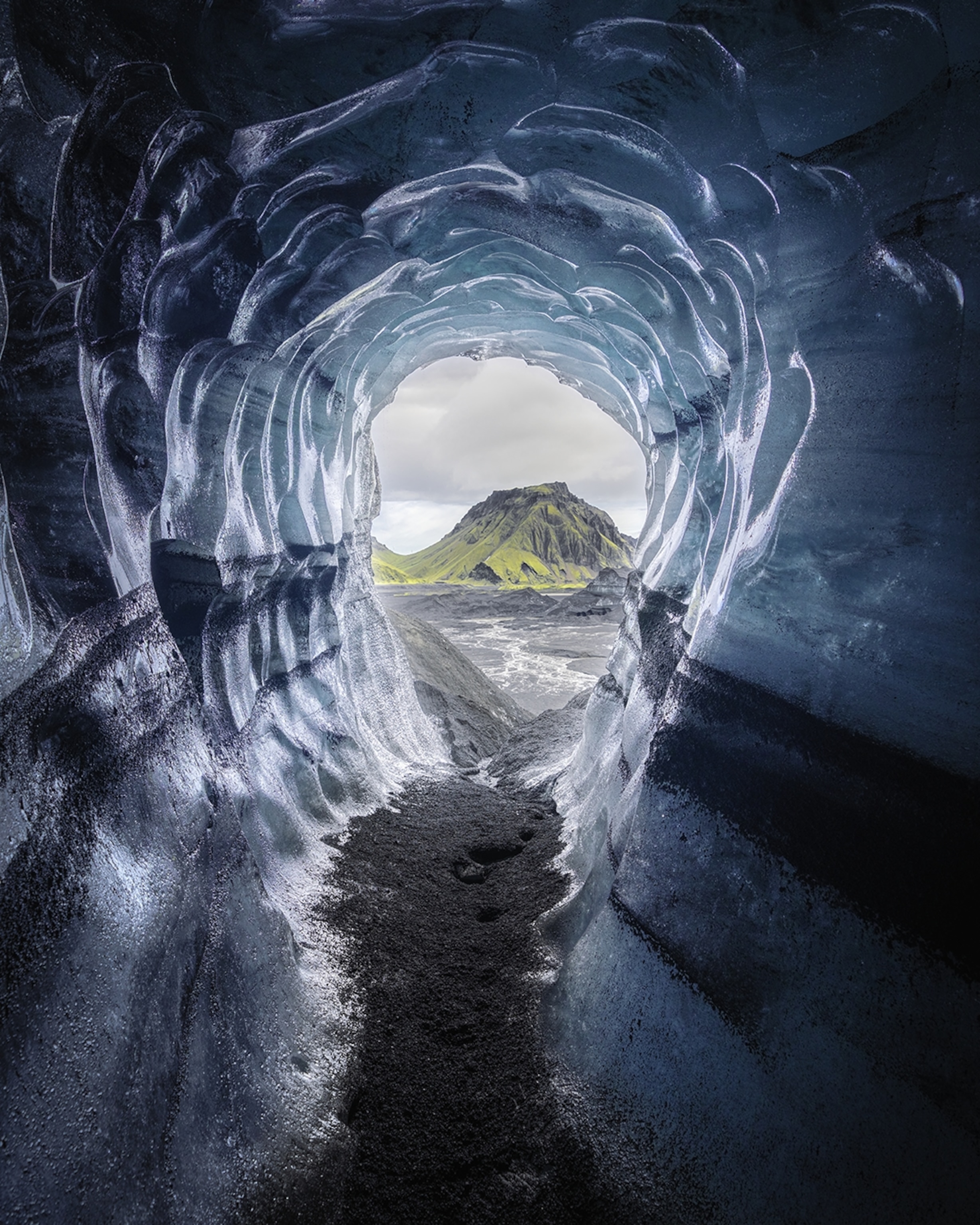 The scalloped entry to an ice cave in Iceland, shot from the inside out.